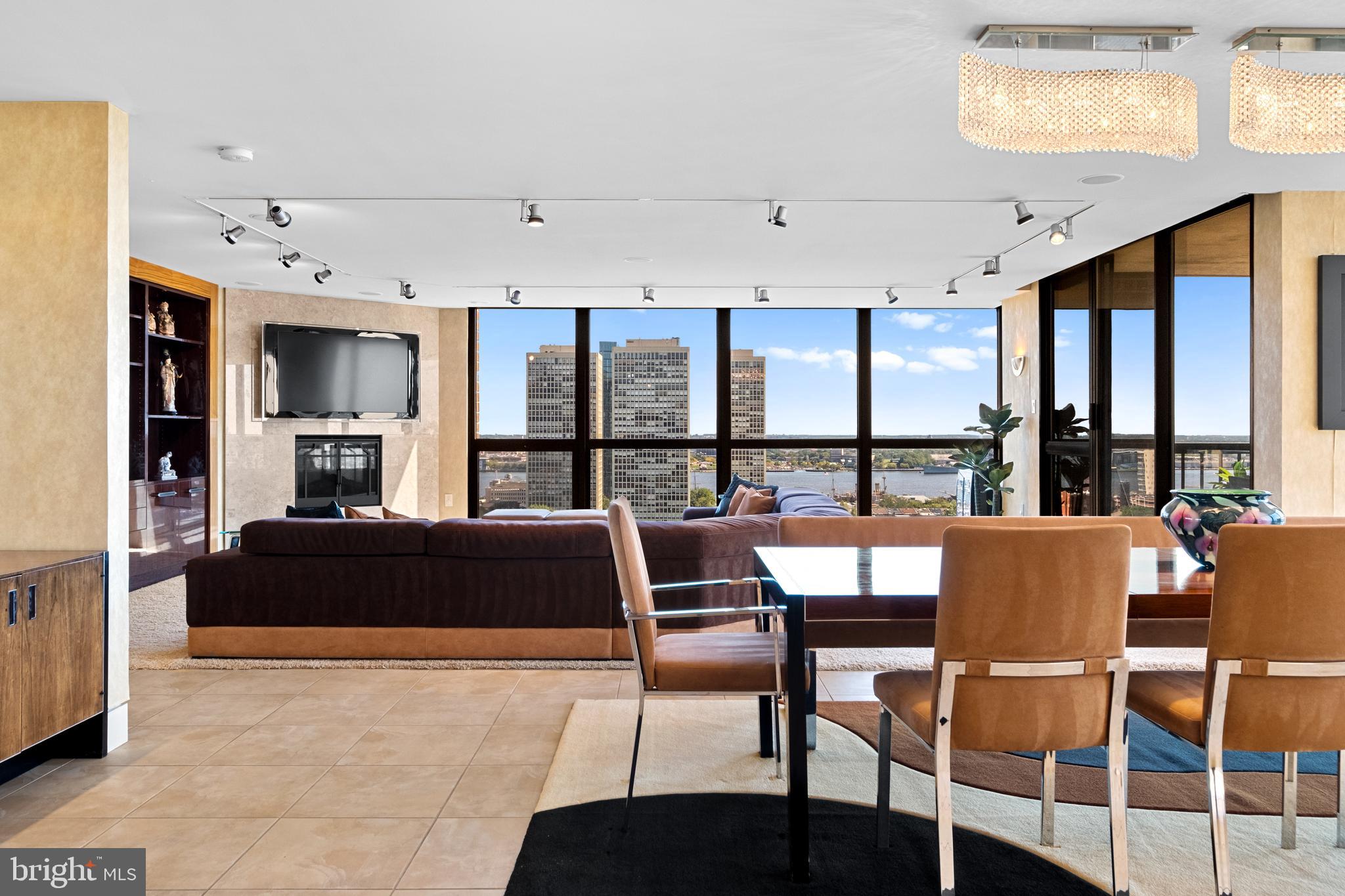 Exceptional residence spanning nearly 4,000ft2 on the 20th floor of Independence Place Condominium on Washington Square Park. Several units were gutted/combined and completely reimagined as this one-of-a-kind home. Floor to ceiling windows and three exposures (South/East/North) allow for incredible natural light and panoramic views. Flexible, open floor plan designed for both larger scale entertaining and more casual, everyday living. The most extraordinary features/finishes throughout, including venetian plaster walls, custom cabinetry, millwork, lacquered wood paneling, doors/trim, integrated lutron lighting system, and recessed baseboard detail.  Gallery entry opens to custom kitchen w/ every conceivable amenity:counter seating for four, custom cabinetry, Wolf induction cooktop, paneled subzero refrigerator, metallic Walker Zanger tiled backsplash, breakfast area w/ built-in banquette, and separate office nook. Ktichen opens to dining and living spaces with South and East views, corner fireplace, and wet-bar/walk-in pantry area with under-counter wine storage and refrigerated drawers. Down the hall, two well proportioned bedrooms share a newer, contemporary hall bath. The over-the-top primary suite is outfit with custom furnishings to accentuate southern views, a second fireplace, and features two walk-in closet/dressing areas, two natural stone clad en suite bathrooms w/ steam shower, jetted tub and frameless glass enclosures, a separate lounge area, and an additional gym/studio space with sauna and kitchenette. Thoughtful laundry area w/ full size, side-by-side machines and custom cabinetry is cleverly hidden behind a sliding door system. Private terraces off the living space and primary suite. Remote controlled custom window treatments and Sonos audio throughout.  No expense was spared, and every detail has been thoughtfully considered in design/construction.  Residents of Independence Place enjoy 24-hour door staff and concierge, newly redesigned lobby, state-of-the-art fitness center, and on-site parking garage with direct lobby access (additional monthly fee). Close proximity to Philadelphia's premier dining, shopping, lifestyle and cultural institutions. Easy highway access into/out of the city.