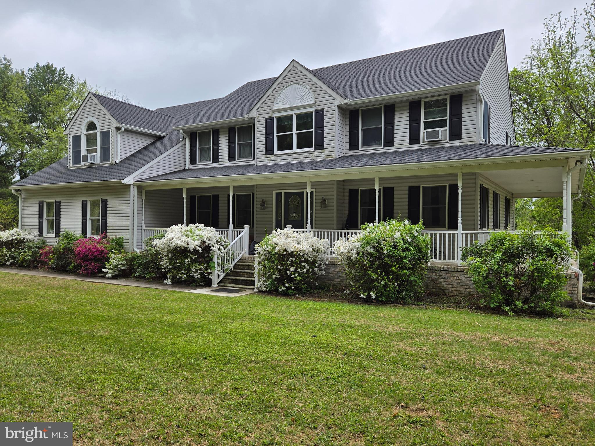 Two-story stately Colonial with a concrete wraparound covered front porch. Level fully usable 2 acre lot with private setting.  Attached oversized two car garage . Fallston schools. No HOA. Approximately 3,800 square feet of finished space with five bedrooms, two full baths, and one half bath. Approximately 1,600 square feet unfinished basement with 10+ foot ceilings and walk-out to the rear.
All major updates completed within the last three to four years: new roof, new furnace, heat pump with oil backup, new central air, four new skylights, new oversized gutters and downspouts, new shutters (all around the house), and a new rear deck (approximately 600+ square feet). New railings on the front wraparound porch.
Interior is in good condition but dated. Features include a two-story entry foyer with crystal chandelier and upper level overlooking entrance foyer.  Also, a two-story family room with floor to ceiling stone fireplace, skylights and upper-level overlook of family room. Kitchen has center aisle, cooktop, double wall oven, walk in pantry, plenty of cabinet space, wine rack, separate tablespace with walkout to deck.  First floor laundry room with exit to rear deck and exit to garage. Formal living room (currently used as office), large formal dining room, fifth bedroom and hall half bath.  Second floor has four bedrooms, two full baths. Pull down stairs to floored attic.  The main bedroom is oversized with three walk-in closets, sun room and sitting room.  Private bath with jacuzzi tub, separate shower, double sinks. One of the Walk in closets is a walk through closet to bedroom 2.  Bedrooms 3 and 4 share second full bath.         Owner/Broker.