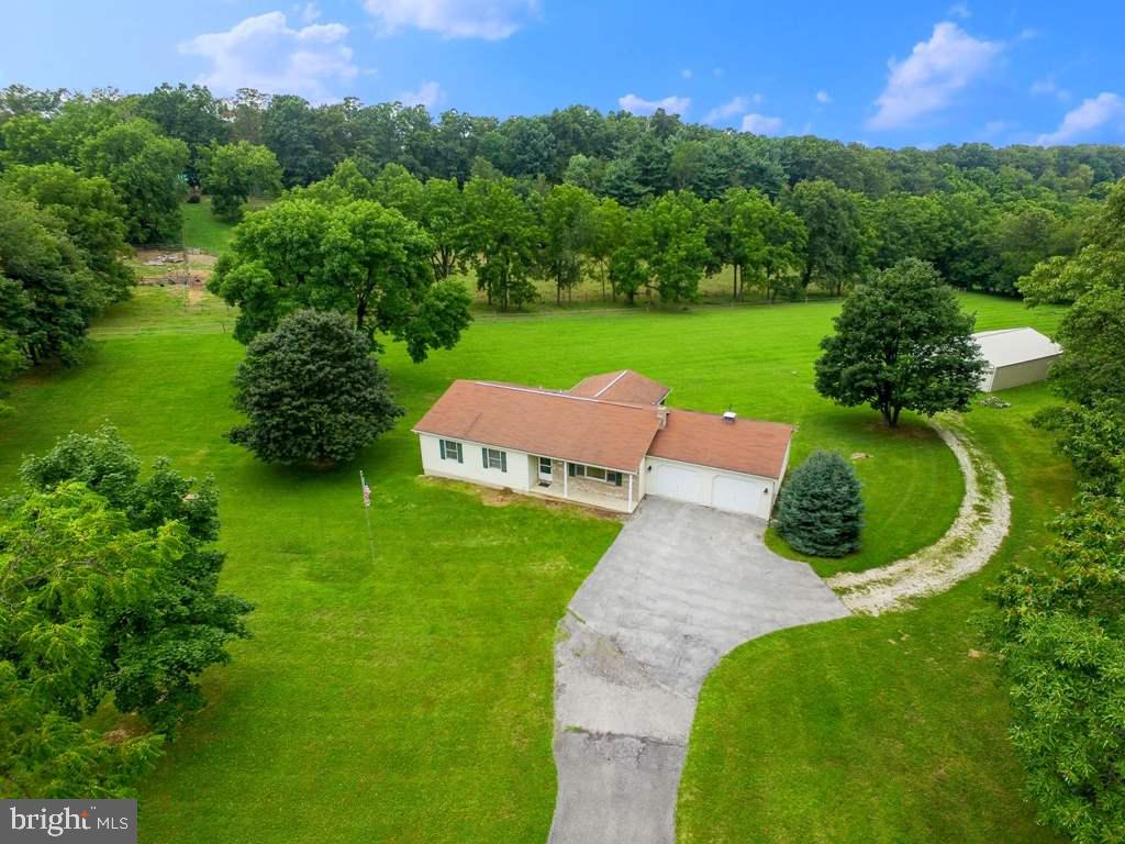 If you are looking for a peaceful & secluded location, this is the home for you! This 3BR,2BA Rancher is situated on a great 2.92 acre lot! LR w/lrg picture window overlooking front yard. DR w/sliding door to rear deck. Mstr BR w/WIC & full BA. 2 addt'l BR's w/dbl closets. Cvrd front porch. Screened in rear deck w/great views of the countryside! Unf LL ideal for future Rec/Game Rm. OS 2 Car gar & 40x30 detached pole bldg w/electric! A must see!