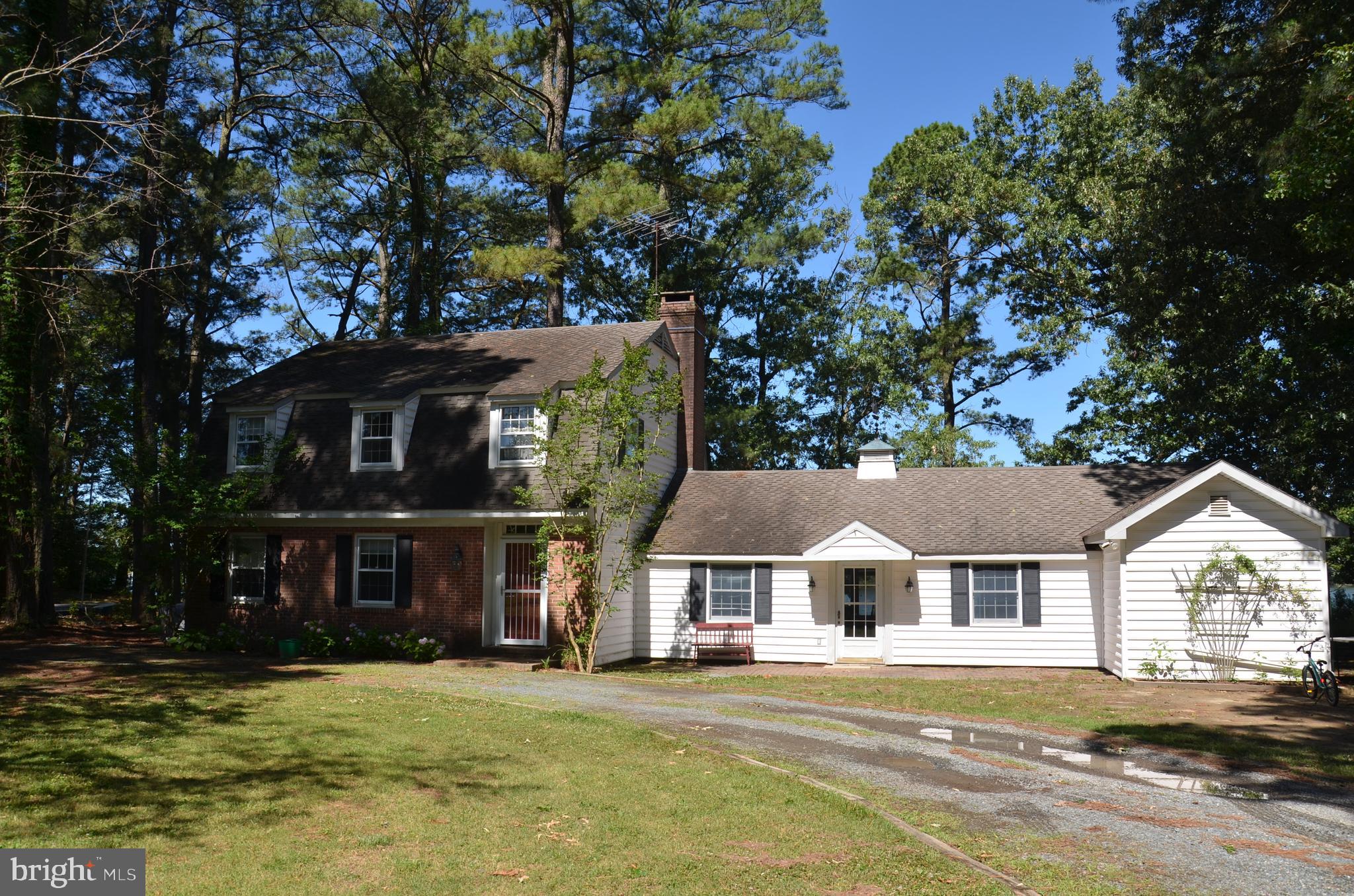 Just 4 miles (five minutes) outside the historic town of St. Michaels, MD, this 15-acre property is located in an area of large, private waterfront estates. Over 300 ft. of protected shoreline. Westerly exposure...Exceptional Sunset views across the sparkling waters of Harris Creek! 120' x 6' pile-driven pier provides approximately 4' MLW. Sited near the water at the end of a long, tree-lined driveway, there is a 3,028 sq. ft. Dutch Colonial-style home.  Constructed in 1966, the house features 4 bedrooms (primary downstairs), and 2.5 bathrooms. The 2-zone HVAC system was replaced with a new, efficient system in 2024. The house is dated, but perfectly livable. Some new owners will decide to update. Others might decide to demolish and replace with a new home. This site and prime location will support a very substantial home. This is a great boating/fishing location. Tilghman Island, with its marinas and waterside restaurants, is just a short, scenic boat ride down Harris Creek from the substantial private dock. The open waters of Chesapeake Bay are just beyond Tilghman Island.