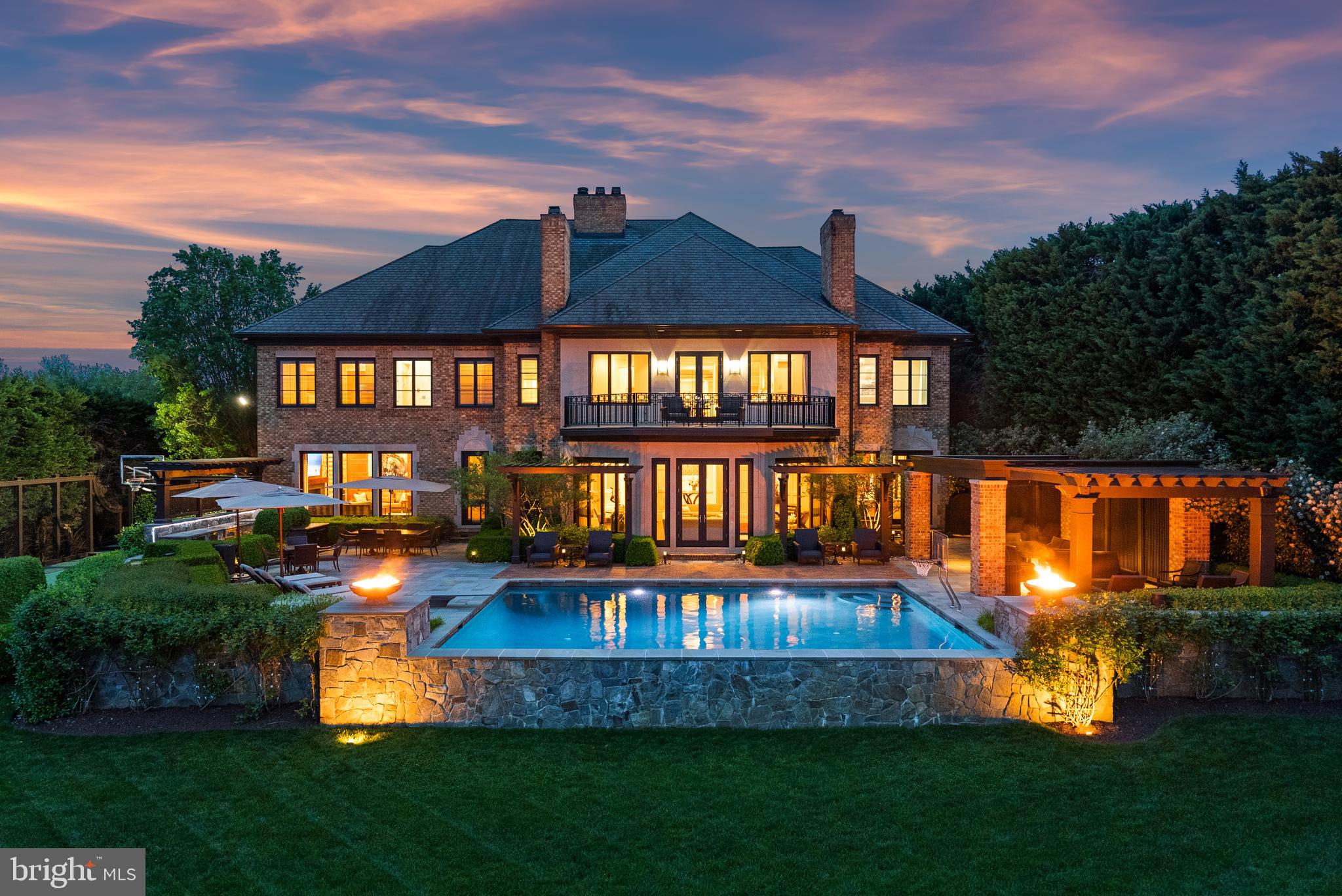 Welcome to your luxury waterfront sanctuary on the Severn River, located in the highly coveted Downs on the Severn community of Annapolis. This extraordinary estate offers unmatched amenities including a private sport court, heated saltwater pool, and private pier with a tram to easily transport you and your guests to the water’s edge for unforgettable days on the Bay. Inside, the craftsmanship is unparalleled and the curated finishes reflect that no expensive was spared to create a home of distinction. The main level flows from the stately foyer, the soaring rotunda that serves as a formal dining room and meticulously constructed office to the beautifully appointed Living room, wet bar, Gourmet Kitchen and Family room all with stunning views of the river below. The attention to detail throughout is designed to impress while creating a warm and inviting home for day to day waterfront living. The bonus dog room with shower, laundry, and refrigerator with access to the dog run is perfect for animal lovers! A fully finished lower level invites relaxation and entertainment with a game room, steam room, home gym, and guest quarters.  The bar area and possible wine tasting room/wine cellar adjacent to the elevator are ready for your personal touches to make it your own. Upstairs, the stunning primary suite is a true retreat with private balcony overlooking the pool and waterfront, dual bathrooms, custom vanities, 2 expansive closets, a private massage room, and a second-level laundry suite with an in-home salon for discreet hair and makeup sessions. An oversized, glass-enclosed luxury shower connects the two spa baths, offering breathtaking views of the river below. The 3 additional ensuite bedrooms provides ample room and privacy for guests and family. Outside, the heated saltwater pool with deep end diving board boasts unobstructed water views and expansive pool deck area including fully equipped outdoor kitchen, a pavilion to enjoy the shade, stunning fire bowls and easy access to the water below.  The deep water private pier features multiple slips and 40,000lb boat lift; creating an effortless and fun atmosphere while cruising down the Severn River to the Chesapeake Bay and beyond.  Experience a life of privacy, resort-style amenities, and timeless beauty in this one-of-a-kind waterfront masterpiece. Welcome Home!