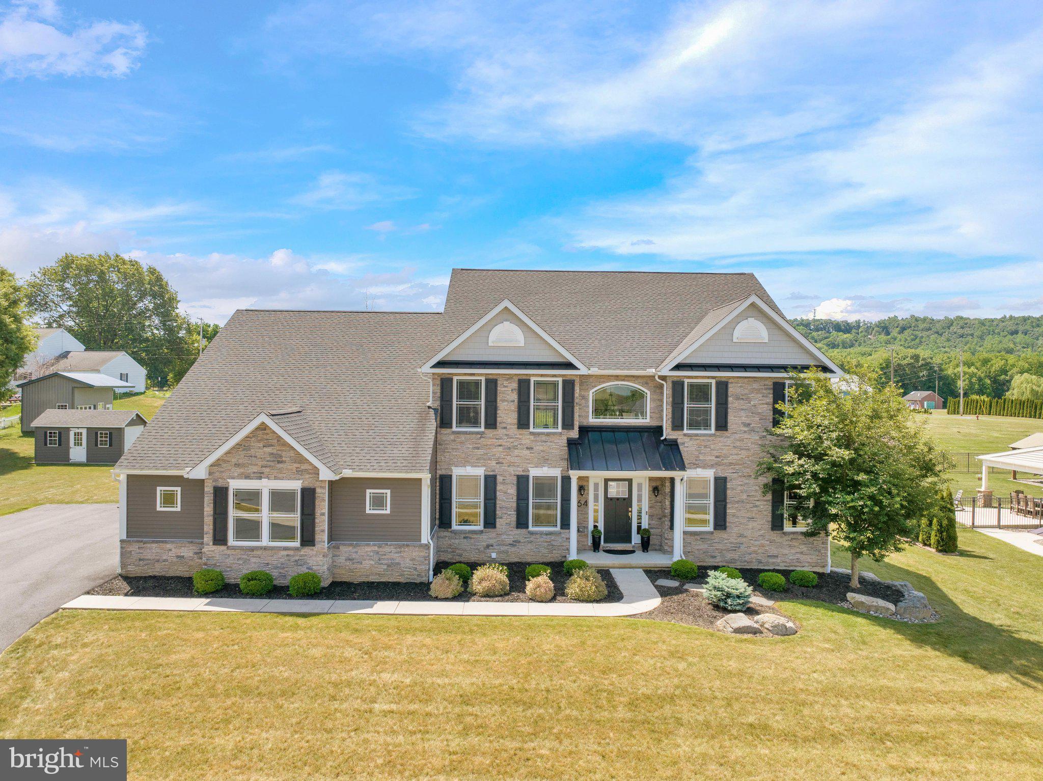 Welcome to 64 Middletown Road, an exceptional custom home nestled at the end of a quiet cul-de-sac in the Willow Crest community within Fleetwood Schools. Offering over 3,700 square feet of beautifully designed living space, this stunning two-story residence is filled with character, charm, and high-end upgrades throughout. From its impressive curb appeal to its thoughtfully designed interior, this home is sure to exceed your expectations. Step inside the dramatic two-story foyer where you’ll find a private home office with French doors on one side and an elegant sitting room that flows seamlessly into the dining area on the other. The heart of the home is the great room featuring a gas fireplace surrounded by a wall of windows that fills the space with natural light creating the perfect gathering place for family and friends. The gourmet custom kitchen is designed to impress with beautiful white cabinetry, a large center island, abundant workspace, all appliances, a custom walk-in pantry, and a bright breakfast area with a vaulted ceiling and access to the spacious Trex deck, making indoor and outdoor entertaining effortless. A highly sought-after main-level primary suite offers the perfect private retreat, complete with dual walk-in closets and a luxurious bath featuring a double vanity and walk-in shower. A convenient first-floor laundry room and powder room complete the main level. The upper level features three generously sized bedrooms, each with walk-in closets, along with two full baths, including a Jack-and-Jill bath shared by two bedrooms. An open catwalk overlooks the magnificent great room below, adding to the home’s impressive architectural design. The enormous basement offers endless possibilities and is ready to be finished to suit your needs, whether you envision a recreation room, home theater, fitness area, or additional living space. Outside, you’ll enjoy a beautifully maintained open yard, a custom storage shed designed to complement the home, and a spacious Trex deck that’s perfect for relaxing or entertaining. A three-car side-entry garage and oversized driveway provide ample parking for family and guests. Luxury, quality craftsmanship, and an unbeatable location combine to make this extraordinary home a rare opportunity. Schedule your private showing today and discover everything 64 Middletown Road has to offer before it’s gone!