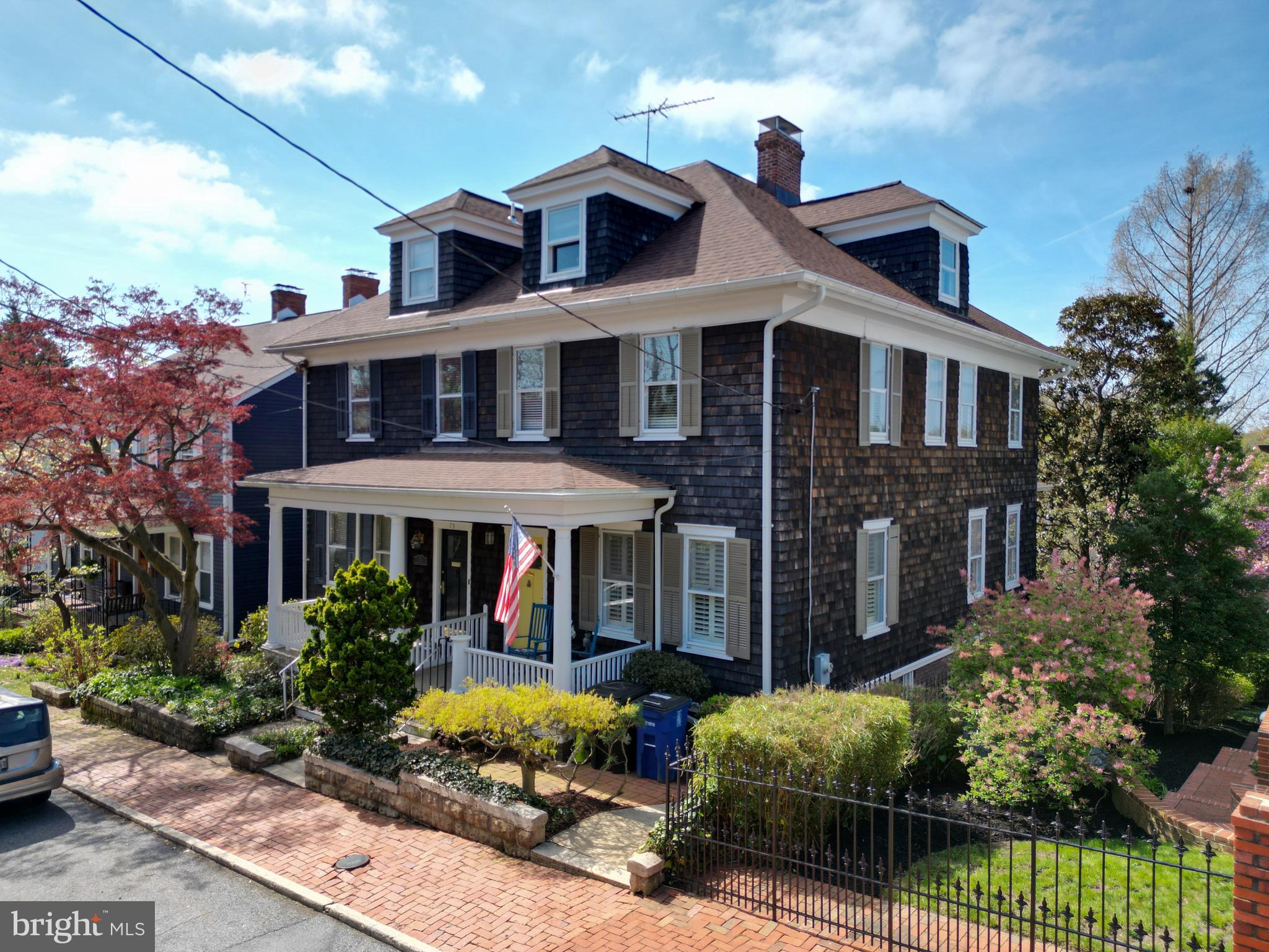 75 Shipwright Street is an enchanting Victorian semi-detached home located in the heart of the Historic District of downtown Annapolis. Built around 1910, this four-level residence offers a blend of original architectural character and modern updates, with significant views of Spa Creek. The property is located in Zone C1 within the historic district, ensuring the preservation of its external architectural integrity. The home features approximately 2,800 square feet of livable space across four finished levels with 5 bedrooms and 3.5 baths, all equiped with eco-friendly bidets. It maintains much of its original Victorian charm, including hardwood floors, moldings, pocket door, and a central hall with high ceilings. The main level boasts a light-filled chef’s kitchen with new quartzite countertops, newer appliances, and a breakfast bar, connecting to a living area with a gas fireplace and a private balcony with wonderful views of Spa Creek. The walk-out basement includes a family room, a full bathroom, and a workshop/laundry area. The new brick patio is surrounded with lush "cottage gardens," providing a private outdoor retreat. A deeded path allows for direct access to the waterfront from your backyard for launching your kayaks and paddleboards. Situated on a secluded street, the property is a short stroll from several major Annapolis landmarks. Residents are just steps from the end of Shipwright Street, where they can catch a water taxi or access slips at the Old Towne Marina. The home is within easy walking distance of the United States Naval Academy, City Dock, and the various shops and restaurants along Main Street. The neighborhood is noted for its tranquil atmosphere while remaining central to the city's vibrant downtown activities. The current owners not only enjoy the property as a second home, they also offer it as a profitable short-term rental, licensed with City of Annapolis. Records are available upon request.  ***Note: Buyers should do their due-diligence if planning to offer the property as a short-term rental (STR).*** This is your chance to own a storied property and a little piece of Annaolis history. Don't miss it! Request your private tour today. ***WATCH THE AERIAL VIDEO TOUR. CLICK THE VIRTUAL TOUR ICON OR VISIT YOUTUBE AND SEARCH "75 Shipwright St Annapolis"***