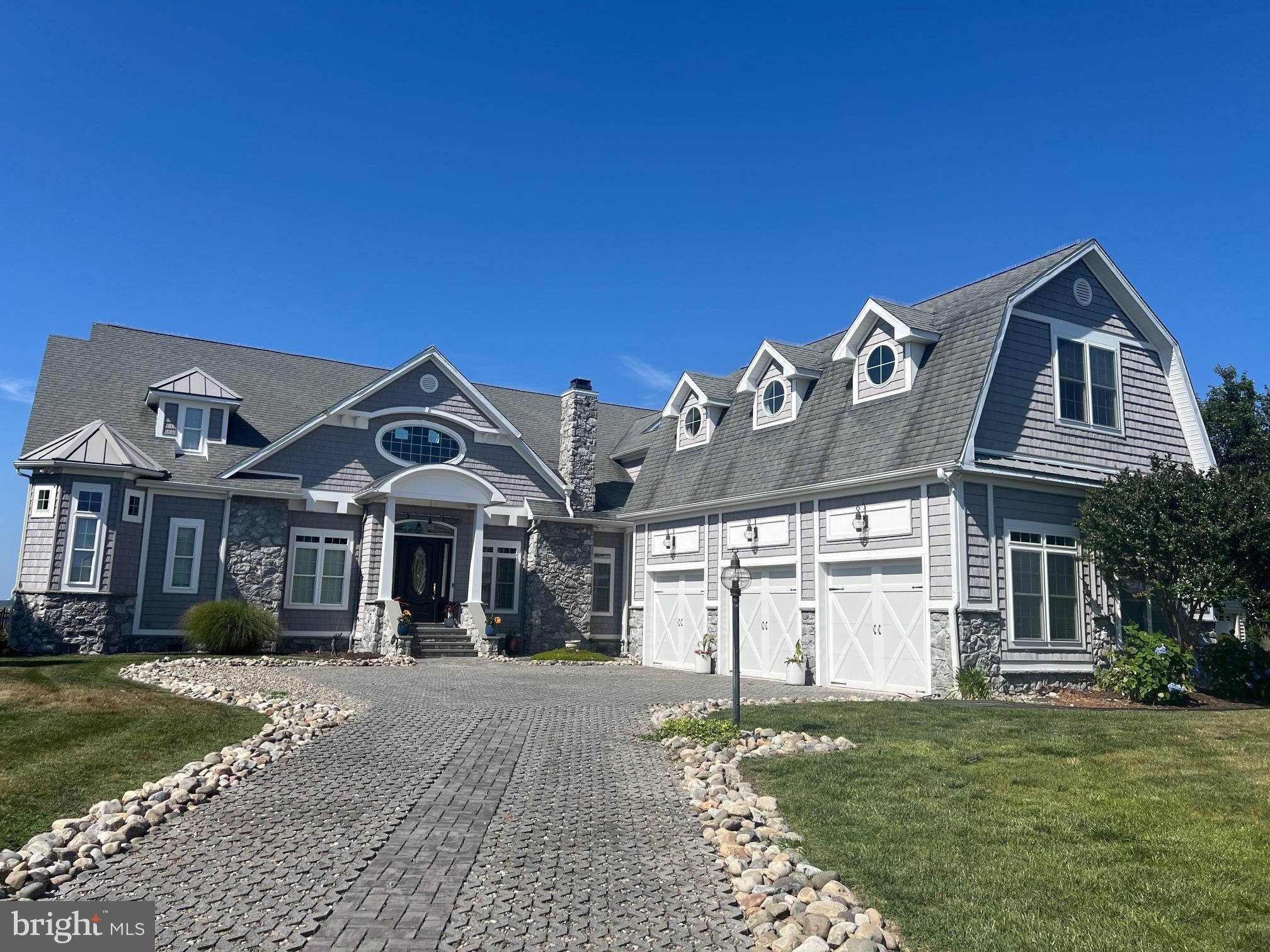 A Coastal Masterpiece with Unmatched Views! 
This one-of-a-kind custom residence—featured on the Sandcastle Home Tour and showcased multiple times in Coastal Style magazine—offers ideal waterfront living. Located in prestigious Lighthouse Sound Golf Club, with panoramic views of the sparkling pond, serene bay, and lush fairways, this home delivers an extraordinary blend of elegance and comfort. Step into your private outdoor oasis, where a heated pool is framed by oversized sliding glass doors on three sides, seamlessly blending indoor and outdoor living. Spanning approximately 5400 sq. ft., this home boasts a remarkable array of amenities, including a theater room, game room, fully equipped exercise room, wine room, and an oversized true three-car garage. Just six minutes from the beach, yet tucked away in an exclusive enclave of only a handful of homes, this property offers privacy without sacrificing convenience. The first floor features a grand primary suite with his-and-her custom walk-in closets and a spa-like bathroom with an expansive walk-in shower. You’ll also find a private home office, a spacious laundry room with ample storage, and a chef’s kitchen with professional-grade Thermador appliances and a large custom pantry. The great room’s gas fireplace adds warmth and sophistication, while multiple HVAC zones ensure year-round comfort. On the upper level, guests will enjoy en-suite bedrooms, a home gym, theater and game rooms, plus a generous lounge area with massive windows framing sweeping water views. Outside, lush landscaping is maintained with a dedicated irrigation system. The home is offered furnished with a few exclusions. This is coastal luxury at its finest—your waterfront dream awaits.