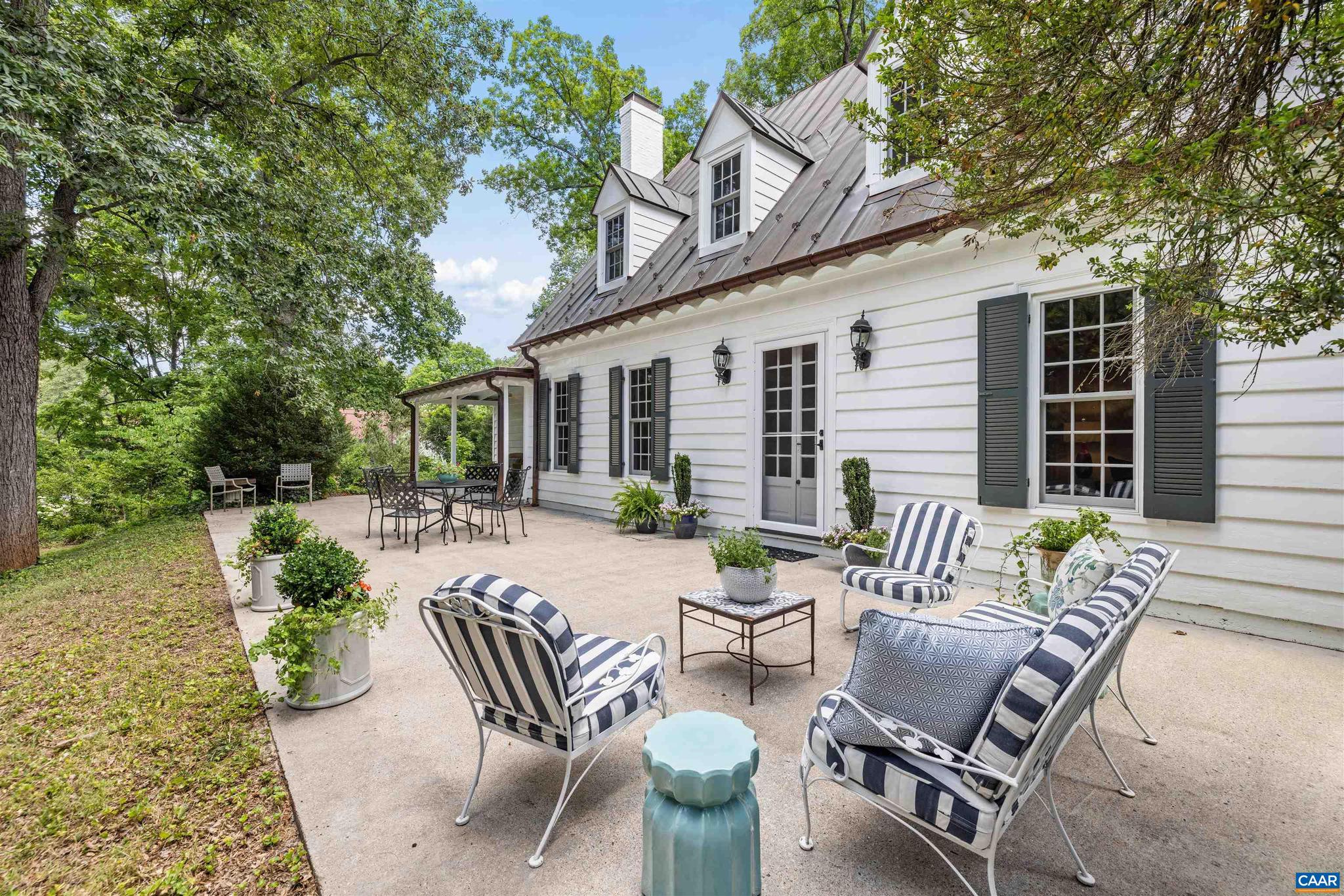 Tucked where one of Rugby?s most coveted streets quietly comes to an end, this storybook 1929 cottage offers extraordinary privacy on over an acre, while remaining an easy sidewalk stroll to UVA Grounds (plus a rear property path to UVA sporting events). Inside, the home is rich with the details that make older cottages so beloved: wide-plank heart pine floors, exposed wood beams, custom millwork, intimate fireplaces, and rooms that feel both gracious and inviting. Updated kitchen and baths honor the home?s original character. The dining room sits opposite the living with flanking fireplaces and French doors opening to a rear patio for dining, lounging, or simply taking in the peaceful view of the expansive rear lawn and magnificent magnolia canopy. The first floor guest bedroom can also serve beautifully as a home office with an adjoining screened porch. Upstairs, a spacious primary suite leads out to an upper terrace overlooking the grounds. A large second bedroom, once configured as two rooms, could easily be returned with the addition of one wall. A versatile loft for study/play/guest overflow. A truly special Rugby offering with cottage charm, architectural character, remarkable privacy & exceptional walkability.,Marble Counter,Painted Cabinets,Wood Cabinets,Fireplace in Dining Room,Fireplace in Great Room,Fireplace in Master Bedroom