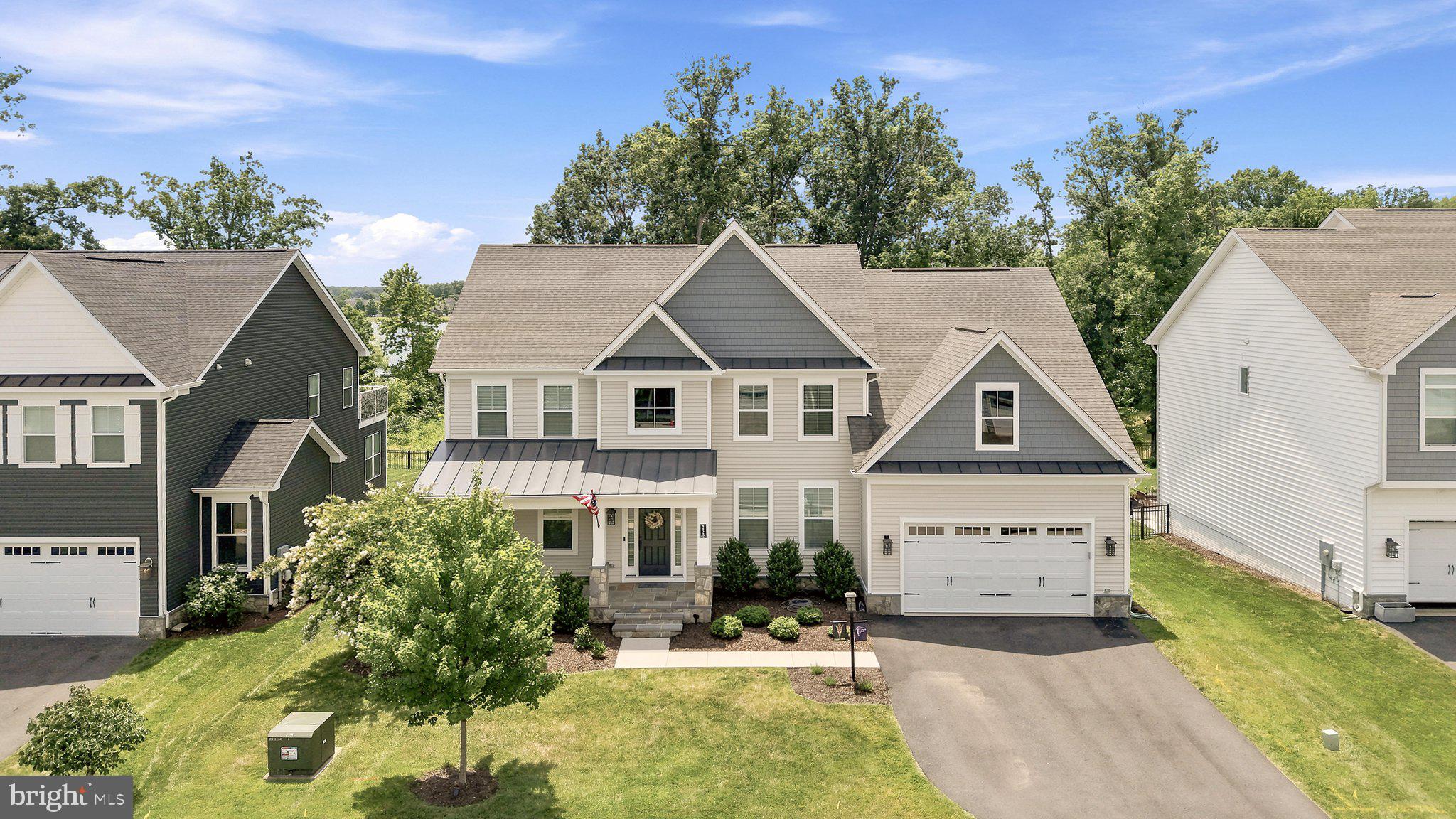 Tucked away on a quiet cul-de-sac and backing to protected woods with peaceful lake views, this exceptional home offers the perfect blend of privacy, luxury, and community. From the inviting front porch to the custom deck and patio overlooking the flat backyard, every space is designed to enjoy the outdoors year-round. Just beyond your backyard, stroll to the lake for fishing, picnics or simply take in the scenic  trails woven throughout the neighborhood.

RARE FIND, this home features five spacious bedrooms on the upper level, offering the ideal layout for today's lifestyle while keeping everyone together on one floor. 

Inside, the open-concept floor plan is filled with natural light and showcases designer finishes, striking light-and-dark contrasts, and a stunning chef's kitchen featuring marble countertops, abundant cabinetry, and generous gathering space perfect for entertaining. Spacious living areas provide room for everyone while seamlessly connecting indoor and outdoor living. 

Beyond the home, enjoy resort-style amenities including two clubhouses, two community pools, a fitness center, tennis courts, basketball courts, playgrounds, fishing lakes, trails, and a community dock. The location is equally impressive, with a local brewery, winery, coffee and ice cream shops, county community center, and dog park all within minutes. Throughout the year, neighborhood events create a true sense of community, with unforgettable Fourth of July celebrations and one of the area's favorite Halloween traditions. This is more than a home—it's a lifestyle.