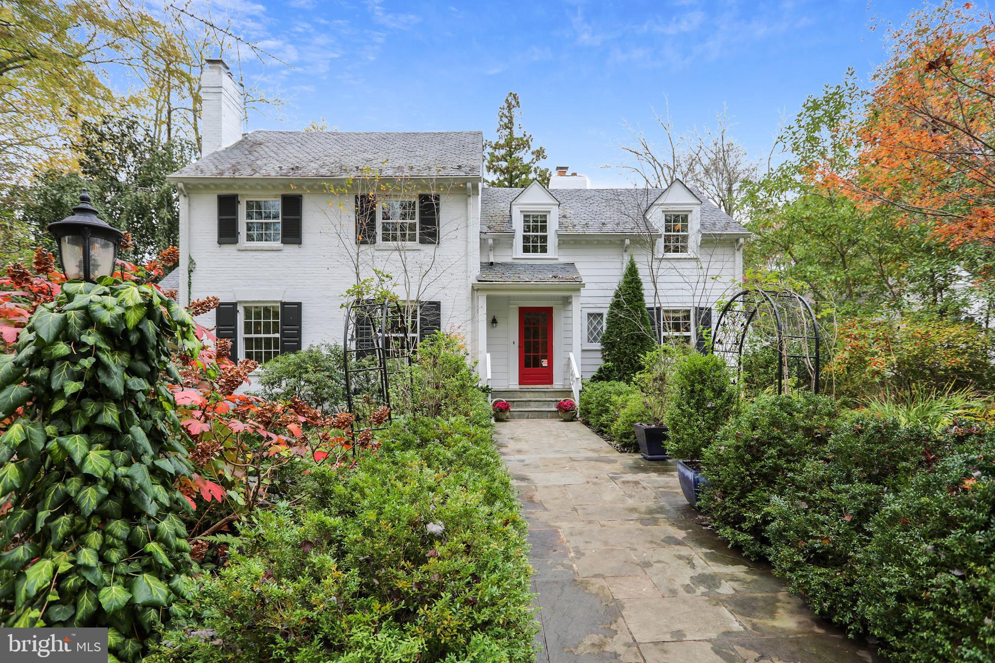 New to market!  This New England style Colonial is situated in a beautiful, private setting with award-winning gardens on a prime one acre lot.   A perfect home for those looking for loads of charm and character without having to sacrifice space or a floor plan suited to everyday living.  For history buffs, the property was formerly on the edge of the Bannockburn Golf Club which turned into the neighborhood of Bannockburn Heights.  This home boasts a recently renovated gourmet Kitchen in 2018 that opens to a large Family Room featuring a gas fireplace, built-in cabinetry and Powder Room.  The mahogany paneled Living Room enjoys a wood burning fireplace, adjacent bar area and a second Powder Room.  The Dining Room offers a classic wood burning fireplace leading to a lovely Sun Room which opens to a walled English Garden patio showcasing an inviting fountain trickling into a small pool.  The patio walkway path leads to a second covered porch with porch swing located off the Family Room.   The rear entrance Foyer with brick flooring is a perfect Mud Room and the adjacent Office can be used for any of your work or hobby needs.    The upper level includes a delightful Primary Bedroom Suite with a wood burning fireplace and a magnificent Bathroom with an oversized frameless glass shower, two walk-in closets, separate water closet and a reclaimed wood vanity topped with stone.  The second Ensuite Bedroom has a renovated Bath with a frameless glass shower and stone surfaces.  There are two more Bedrooms and an updated hall Bath.  On the grounds, there is a separate Cottage with full Bath that is currently used as a second Office but could be private living quarters.  The garden and grounds are breathtaking with rose-covered arbors and a wrought iron gazebo, flagstone pathways meander through numerous garden beds featuring  specimen plants, peonies galore and flowering magnolia trees.  The lawn area is large enough for soccer games or a possible future pool.  The circular driveway graces the front entrance and an additional driveway accesses the over-sized garage and rear entrance of the home.   A superior location close to downtown Bethesda, the C&O Canal, shopping and schools in the Whitman cluster.