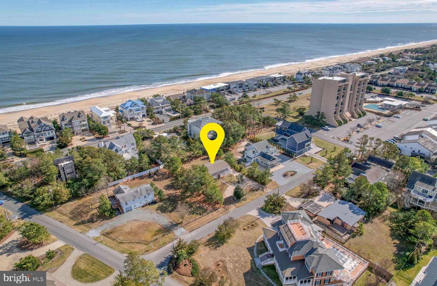 Welcome to 56 Harbor Road located in the exclusive community of North Shores and within 400 feet of the community private beach. This home is a quaint beach retreat situated on a .34 acre lot, that offers the rare potential to build your dream home in one of Rehoboth Beach's most desired locations. This location offers low traffic and excellent proximity to all of the community amenities and the very popular Gordon's Pond Trail through Cape Henlopen State Park. North Shores is an amenity-rich community, offering an outdoor pool, 2 tennis courts, private beach, marina, and security. The home includes 4 bedrooms, 2.5 baths, an inverted floor plan and vaulted ceilings with exposed beams. The first level features a foyer, 3 bedrooms, full bath, and laundry closets. Step upstairs to find an open living and dining area, 3 sets of sliders offering an abundance of natural light, updated kitchen with granite countertops, breakfast bar, tile backsplash, pantry, and a primary suite. Exterior features include a second-story deck that spans the rear of the home, first-floor patio, 2 storage closets for beach toys, outdoor shower, charcoal grill, gas grill, and exterior lighting. This home has been well maintained and includes new water heater and HVAC in 2022. Excellent opportunity!