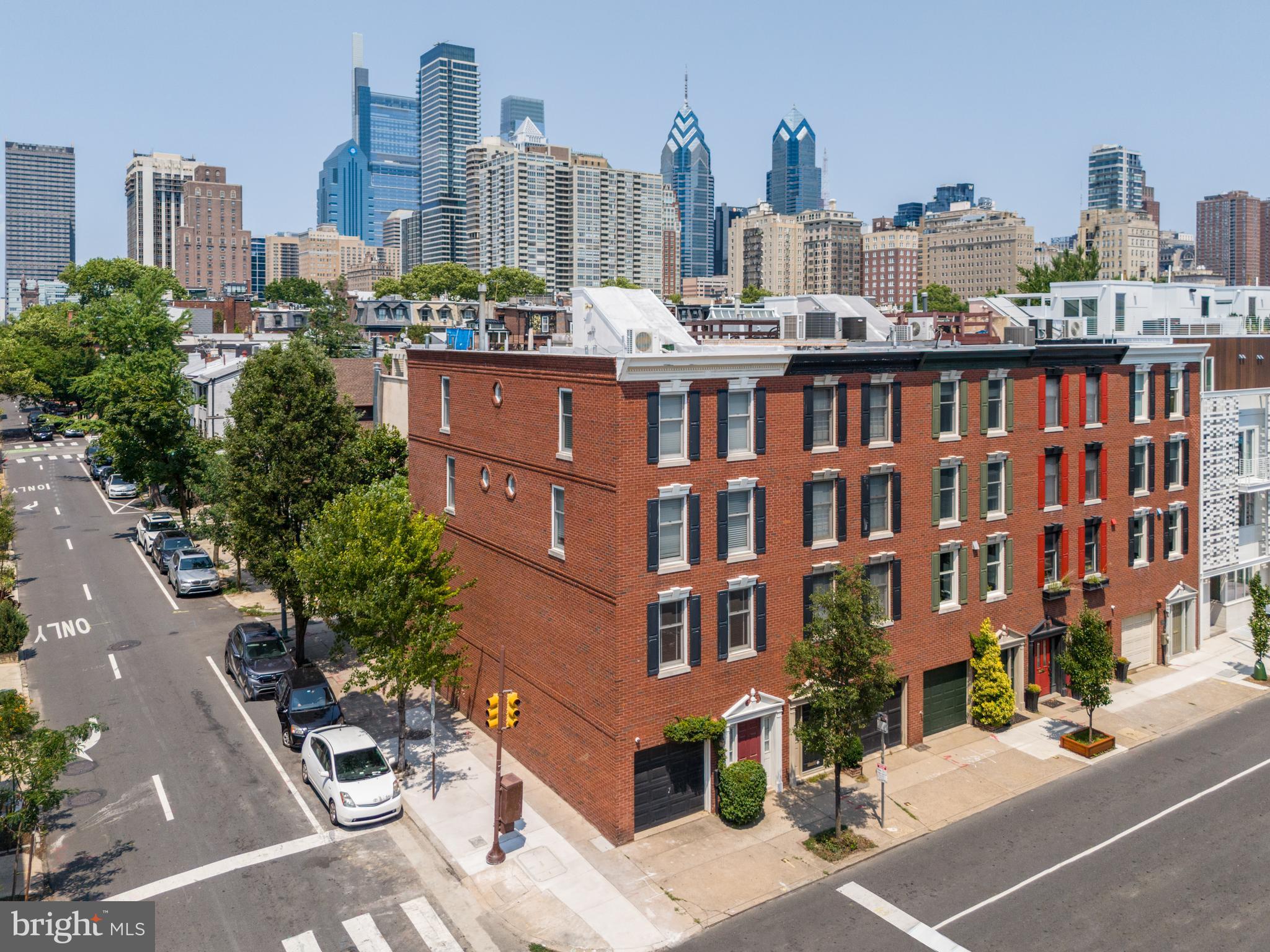 Welcome to this exceptional corner property in the prestigious Rittenhouse Square neighborhood, offering refined urban living in the heart of Center City. Don’t miss this meticulously maintained home, featuring numerous upgrades that make it a true masterpiece.

Upon entering through the main entrance or the attached single-car garage, you are greeted by an elegant marble foyer. This floor features a renovated powder room, a spacious coat closet, and a utility room with a new washer/dryer and a new water heater with water pump. A large family room with abundant additional closet space completes this level. Sliding glass doors provide easy access to a custom-designed, secluded patio-garden, perfect for relaxation, entertaining, and al fresco dining.

The second level boasts an impressive open space with refinished wood floors, exquisite crown molding, and dual Juliette balconies overlooking the rear patio. A cozy wood-burning fireplace adds warmth and character to the inviting living area. The formal dining room is spacious enough to host large gatherings and seamlessly connects to the well-appointed kitchen. Designed for both culinary creativity and casual socializing, the sunny kitchen is a chef's delight, featuring new, stainless steel appliances and ample storage.

Ascending to the third floor, gleaming hardwood floors lead to a large guest room with a brand new en suite bathroom, complete with a custom vanity and mirror. An additional full hall bath has also been beautifully redone. Completing this floor is a spacious southern facing bedroom that boasts natural light throughout the day.

The sun-soaked fourth floor primary suite is a luxurious retreat, featuring a skyline view, a lavish Carrara marble bathroom, an expansive walk-in closet with custom shelving, and a dedicated laundry closet for added convenience. The fourth bedroom on this floor can serve as an additional bedroom or a sophisticated home office, complemented by a new kitchenette—perfect for early morning coffee. The stairs lead to a pilot door, providing easy access to the newly replaced and resloped roof.

Experience the ideal blend of design and functionality in this remarkable home. It is a must-see for discerning buyers seeking elegance, comfort, and urban sophistication.