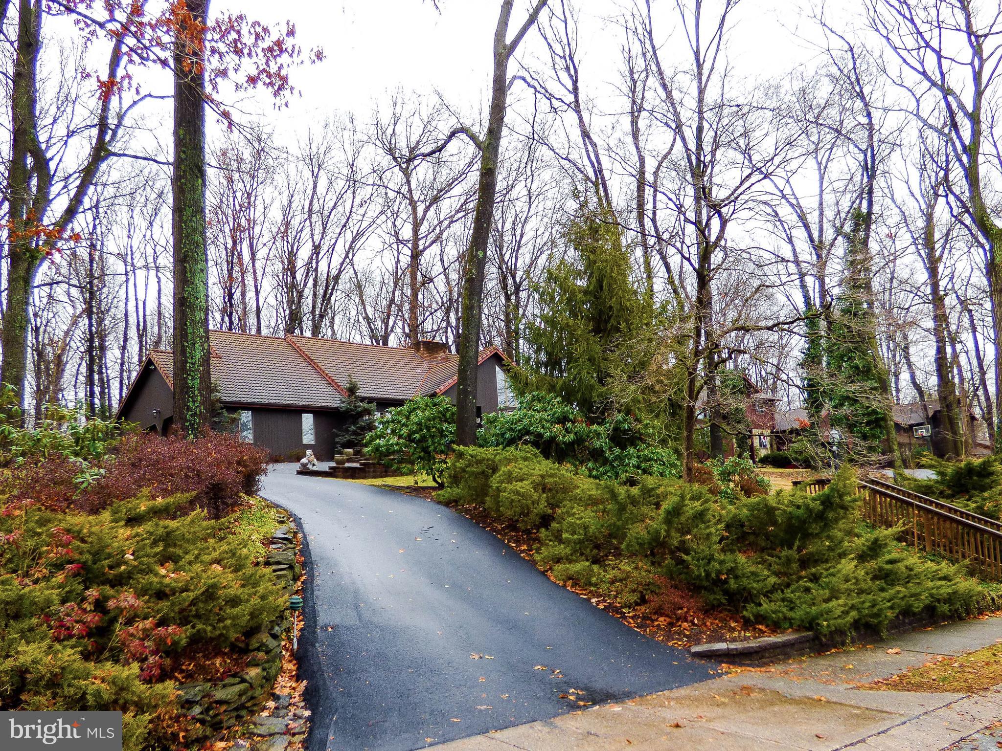 Impressive, well built, well maintained, lifetime tiled roof salt box backs to woods, boasts granite counter tops, 2 sided wood burning fireplace with insert, inlaid hardwood floors, cypress wood exterior, textured patios, private backyard and end load 2 car garage!  Over 3,500 sq. ft of finished space with an open contemporary feel, architectural windows, private wooded views, keener custom kitchen and all quality materials.