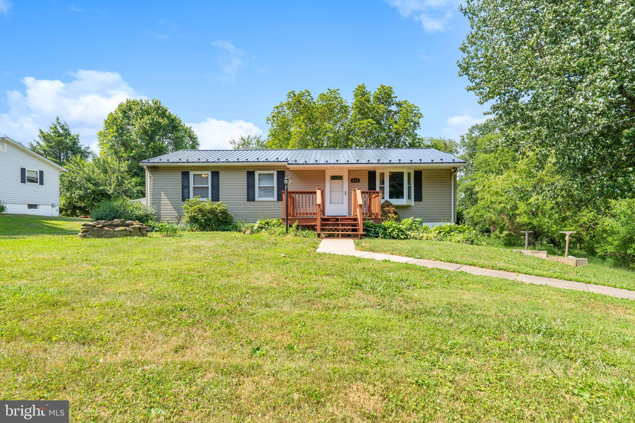 Move-in ready rancher situated on half an acre in Rising Sun School District (buyer to verify)! The main level offers a living room, new white kitchen with ample space for a dining table, beautiful sunroom, 3 spacious bedrooms, and 1 full bath. The walk-out lower level offers space for future rooms or storage. Exterior features include a front deck, wrap-around rear deck, and storage shed. Upgrades include a new kitchen (2023), new interior doors and exterior kitchen door (2023), brand new metal roof (June 2026), new water heater (installed 2023), and new pressure tank (2023). Schedule your private tour today!