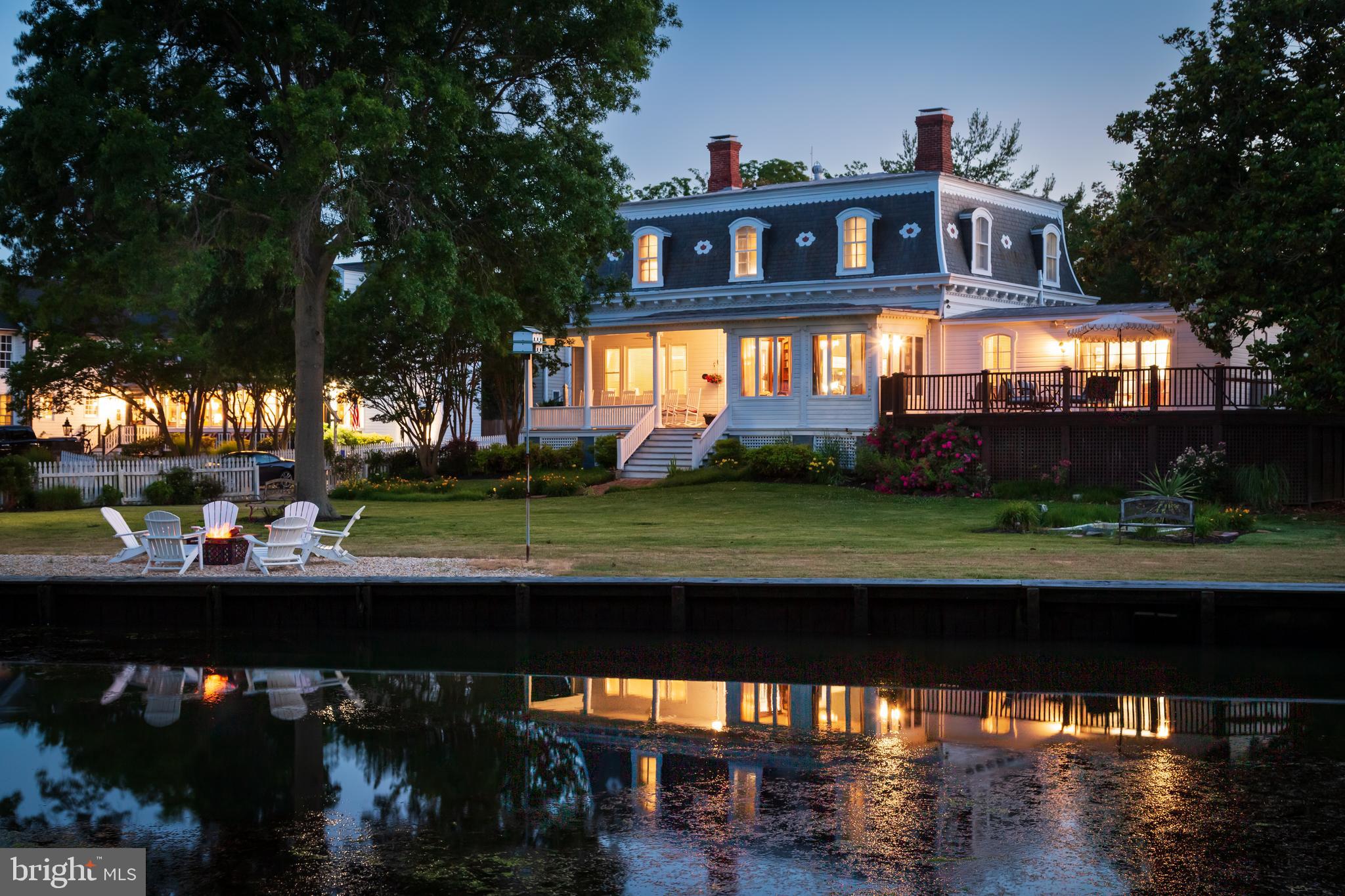 205 Cherry Street is one of the most prestigious addresses in historic St. Michaels.  Originally built as a single-family residence, it currently operates as an Inn.  It is being marketed both as a 7 bedroom inn and also as a single family residence, offering 5 bedrooms (including the first floor primary bedroom suite).  The original living room/office with fireplaces on the first floor are currently being used as bedrooms  for the inn but can easily be converted back to living areas. (see virtual images in photos). The beautiful front lawn provides a park-like setting with one-of-a-kind water-views overlooking St. Michaels Harbor. There is also a 2 bedroom, 2 bath guest cottage on the property.  The property directly across the street  (FKA The Hambeleton Inn) was purchased as a private residence  and serves as a second home to its owner.  This is a wonderful opportunity to own  a landmark  historic  inn or primary or second home in the heart of St. Michaels.