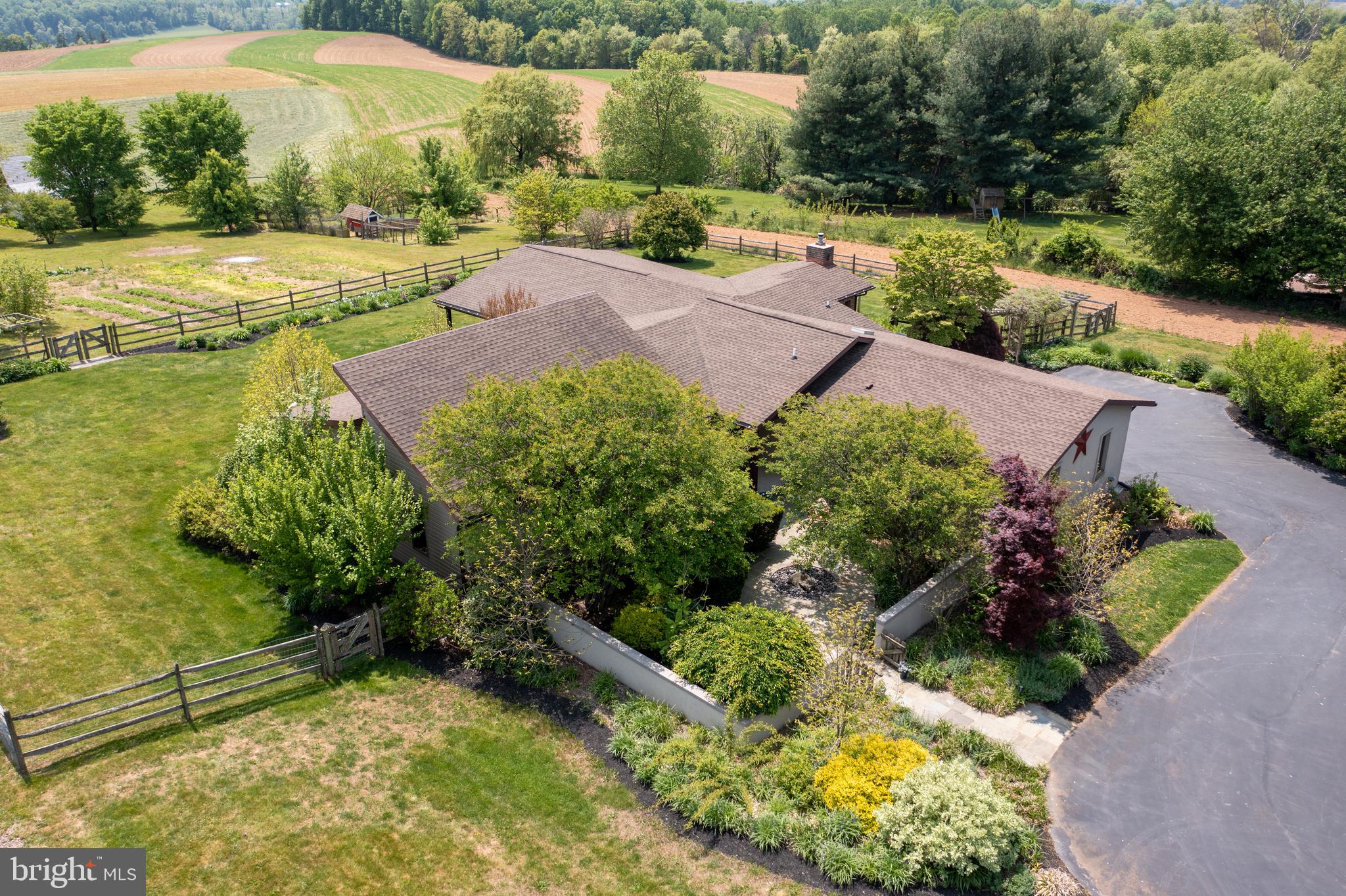 This contemporary ranch-style home in the Lampeter Strasburg school district is not only beautiful but also energy-efficient with geothermal heat. Vaulted ceilings, cast concrete countertops, and a sub-zero refrigerator are just a few of the high-end features of this stunning property. Cozy up next to the gas fireplace or relax on the large covered deck with a tranquil water feature and take in the expansive farm views. This homestead includes fruit trees, berries, vegetable gardens, and a chicken coop, perfect for sustainable living. With 3 bedrooms, 2 full bathrooms, and a reconstructed historic log cabin with an authentic feel, this property has it all.  Don't miss out on this unique and energy-efficient property!  ***Open House on SATURDAY, May 13 from 1:00 to 3:00 PM***