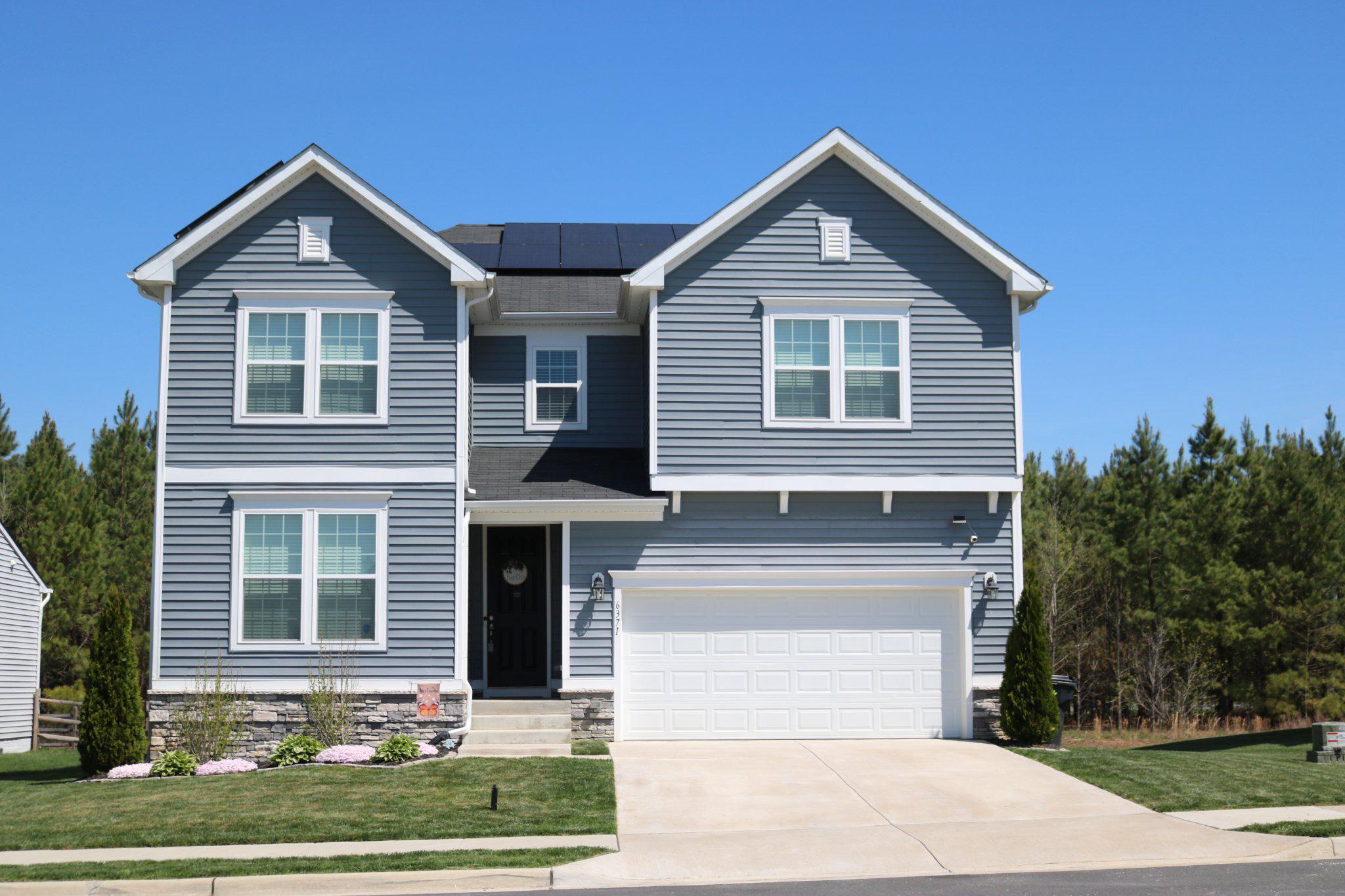 Welcome to Pointer Lane - a lovely and spacious home just over 3 years young featuring an abundance of built-in savings with solar panels offering affordability without sacrificing quality! Water and electric bills for the last 12 months available for review (speak with your agent for access). Convenient to Dahlgren Naval Base, this home features an incredibly spacious floor plan with nearly 3600 finished square feet, 9-foot ceilings and 8-foot doors on the main level, 9-foot ceilings in the finished basement, a private office space, seamless flow from family room to kitchen which boasts a huge walk-in pantry with wood shelving, granite countertops, and stainless appliances, great primary bedroom with a very large walk-in closet, 4 additional spacious bedrooms (2 of which also have walk-in closets!), 3.5 bathrooms (all with quartz countertops and ceramic tile), and a convenient upper-level extra-large laundry room with plenty of space for folding table, storage, or other extras! The layout is designed for both relaxation and entertaining. Step outside onto your beautiful maintenance-free deck overlooking a wonderful level fenced-in yard that backs to trees and a walking path, perfect for morning coffee or evening gatherings. Govee permanent lighting included with sale! Don't let this one slip away!