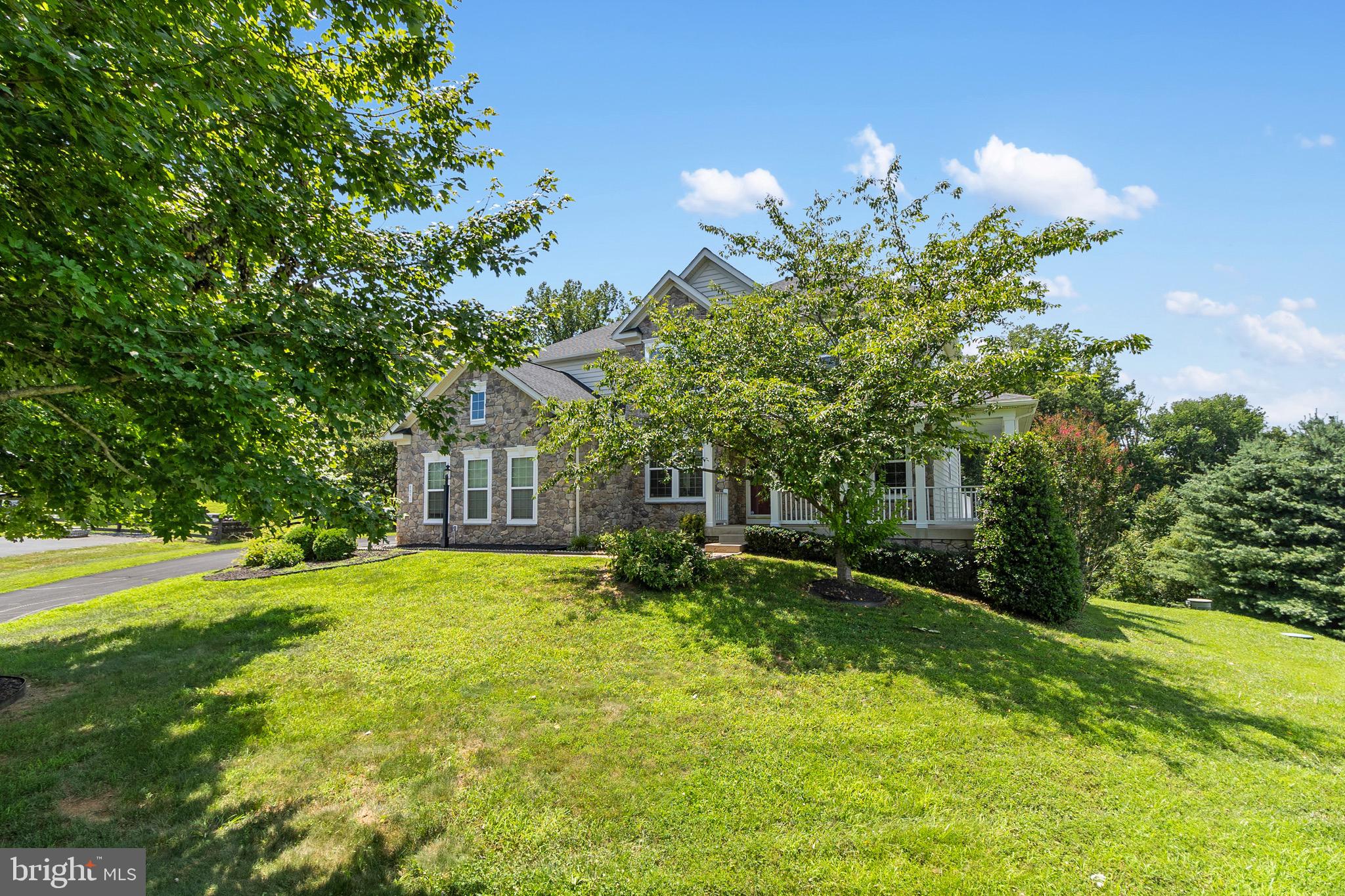 Massive Price Improvement on an amazingly well kept home. Come tour !
Welcome to your beautiful sanctuary. This exceptional home offers 5 large bedrooms & 4 baths. Panoramic hillside views, privacy, and many upgrades and improvements as well as the space to add more to your own vision. 

The northeast-facing exterior features a Natural Fieldstone Mosaic façade, and a charming wraparound front porch along the right wing of the home. Inside, a dramatic 30-ft ceiling grand foyer opens to an parlour & banquet room. The open-concept main living area is where you will find 9ft ceilings throughout, 6-ft-wide natural fieldstone mosaic fireplace, recessed lighting, recessed surround sound speakers, connected to a 75” 4K Samsung TV, included with the sale. Office and half bath on right wing and kitchen and sunroom to the left. 

A library/office with 8-ft French doors houses a massive oak executive desk, ideal for working from home. A nearby half bath adds convenience. The chef’s kitchen features a 5’ x 6.5’ island, granite countertops, stainless steel appliances, walk-in pantry, and butler’s pantry, with a new gas range burner installed Dec 2025. Light floods the XL sunroom with swindow treatments and blackout curtains, offering full backyard views. New refrigerator with glass door installed 2026. 

Step outside to the 672 sq ft deck (2018), furnished with a cast-iron dining set for entertaining. Lighted steps lead to a private backyard oasis with mature trees, expansive lawn, and sweeping valley views.

The second floor offers four fully furnished bedrooms, all with walk-in closets. The primary suite features a king-size bed, separate sitting area, and a spa-inspired bathroom with soaking tub, double vanity, private toilet room, and dedicated dressing area. The three additional bedrooms each include queen-size beds and matching hardwood armoires made of mahogany and oak with walk-in closets two of the three bedrooms. A second-floor laundry adds convenience.

The walk-out basement includes finished gym and entertainment space and a walk out sliding door to another outdoor entertainment covered patio. The finished lower level features a bedroom with egress window, walk-in closet, full bath with real ceramic tile, and abundant natural light. Exercise equipment is included, and a swing attachment remains. Extra large space for another bedroom or sauna, playroom. Yours to choose!

Additional features/updates:
    •    New range, refrigerator 2026
    •Charcoal black asphalt shingle roof (2019) w/ 30-yr warranty
    •    Concrete patio w/ ramp & steps (2019)
    •    Whole-home salt-water softener system (2022)
    •    New underground sump pump replaced 2025
    •    Exterior septic pump replaced; system serviced 2019
    •    Irrigation system, weatherized; control panel
    •    New Flooring throughout 1st & second floor 2015
    •    New Ceramic Tile in Basement 2019
    • Whole home Painted 2025
    • Exterior Pressure washed 2026 spring
    • Lawn reseeded 2026 spring 

This home offers extra living space, comfort, and turnkey living with breathtaking views—an unparalleled opportunity in Jamison Farms.