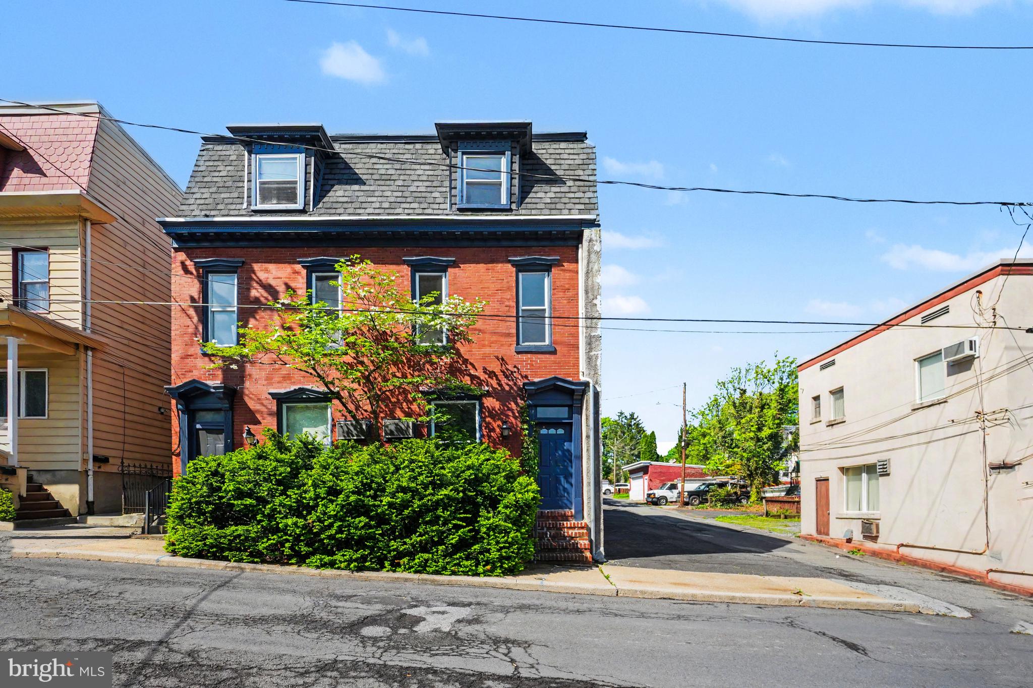 Welcome to this beautifully maintained and exceptionally spacious home in the heart of Pottsville — offering the perfect combination of charm, functionality, and flexible living space. With 5 bedrooms, 2.5 bathrooms, multiple bonus areas, and private off-street parking for up to 8 vehicles, this property is ideal for growing households, multi-generational living, or anyone seeking extra space to live and work comfortably.

From the moment you arrive, you’ll appreciate the inviting curb appeal featuring a beautiful flowering dogwood tree, mature maple trees, evergreen landscaping, and peaceful patio garden areas that create a warm and welcoming setting.

Inside, the home offers a thoughtfully designed layout filled with character and versatility. The main level features a spacious living room, formal dining room, convenient half bathroom, bright patio room, and a flexible office or bonus space with its own private entrance — perfect for a home office, guest suite, playroom, or additional bedroom.

The second floor offers a comfortable and inviting primary bedroom complete with large windows, recessed lighting, and generous his-and-hers closets. An additional bedroom and a full bathroom are also located on this level, along with a beautifully designed eat-in kitchen featuring Wilsonart Thinscape countertops, tile backsplash, Kraus porcelain undermount sink, Moen gooseneck faucet with spray attachment, garbage disposal, dishwasher, and electric stove. Just outside the kitchen, enjoy a private second-floor deck — the perfect place for morning coffee or evening relaxation.

The third floor provides two additional spacious bedrooms, another full bathroom, and an oversized walk-in storage closet, offering plenty of room for storage and organization.

Additional highlights include:

* 2 full tile bathrooms with quality Moen and Delta fixtures along with American Standard toilets
* Large basement with approximately 500 square feet of storage space
* Laundry area with washer/dryer hookups, laundry tub, and folding station
* Efficient EFM oil furnace and 40-gallon Rheem electric water heater
* Classic radiator and cast-iron baseboard heating system
* Attached side parking lot accommodating up to 8 vehicles — a rare and valuable feature

Conveniently located near local schools, parks, shopping, and everyday amenities, this unique property offers space, flexibility, and comfort both inside and out.

Don’t miss the opportunity to make this exceptional Pottsville property your next home. Schedule your private showing today!