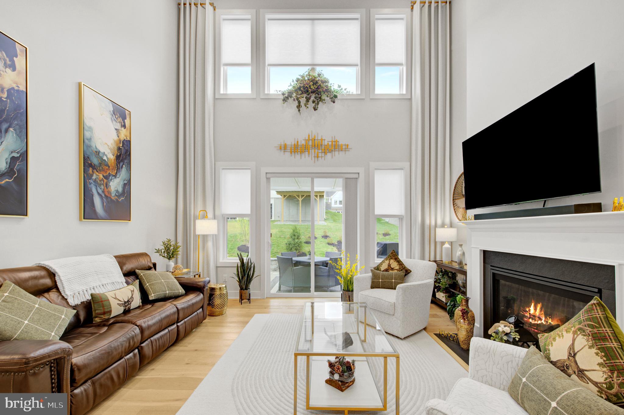 Motivated Seller! Why wait for new construction when this beautiful, "almost new" home , loaded with upgrades, is available right now?!  An extraordinary expanded townhome in the highly sought after Preserve At Marsh Creek 55+ community has just come to market- and it truly shows better than a model home. This stunning 3 bedroom, 2.5 bathroom corner property offers luxury, comfort and resort-style living at its finest.
Step into the grand foyer and immediately feel the elegance of gleaming oak hardwood floors that flow seamlessly throughout the main level. The modern open concept design features an expanded great room with a dramatic two-story vaulted ceiling, an enclosed gas fireplace, recessed lighting and an impressive wall of windows dressed in custom draperies. Sunlight pours in, creating a warm and inviting atmosphere. Sliding glass doors lead to an expansive stone patio with a paver wall, custom pergola and privacy fencing- the perfect outdoor retreat for barbecues, family gatherings or simply relaxing with a book and soaking up the sun.
The upgraded chef's kitchen is a showstopper, offering stacked wall cabinets with enhanced crown molding, a full custom tile backsplash, a large island that comfortably sits four, Whirlpool appliances,  a built-in wall oven and microwave and a spacious pantry. The adjacent dining area is ideal for both everyday meals and more formal entertaining.
The first floor primary suite feels like a private spa. Enjoy a sophisticated tray ceiling, a beautiful wall of windows and a luxurious ensuite ceramic tiled bathroom featuring a double vanity with upgraded cabinetry, elegant lighting and an oversized shower with bench seating.  A  large walk-in closet completes this serene retreat. A discreetly located powder room, laundry room and a two car garage with epoxy floor round out the main level.
The second floor offers a beautifully appointed loft- ideal as a living room, office or creative space, (currently being used as a family room and home office.).  Additionally, there are  two generously sized bedrooms featuring plush carpeting, recessed lighting and lots of closet space.  The full bath mirrors the home's refined aesthetic with a double vanity, upgraded cabinetry and designer fixtures.  A custom theater/game room adds a unique touch of luxury and entertainment and can be converted to a storage room, making this home truly one-of-a-kind.
INCLUDED in the sale of this home in "as is" condition and at no monetary value - LG refrigerator/freezer in kitchen (one yr. old), all outdoor wicker patio furniture, outdoor rug, cushion box and cushions inside, (barbeque grill and fire pit not included), brown leather couch in living room, both the mounted TV and the yellow couches in the loft, everything in the cinema room with the exception of the racing chair and monitor. The barbeque grill, fire pit, washer and dryer are available for sale and are negotiable. 

Beyond the home itself, the Preserve At Marsh Creek offers an unparalleled lifestyle. The resort-style clubhouse invites you to unwind and connect. Enjoy the refreshing pool, pickleball courts, fitness center, yoga studio, card room and vibrant social calendar. Every day feels like a vacation! 
You have earned the right to live beautifully. Welcome to a home where luxury, comfort and community come together in perfect harmony.  The  Preserve At Marsh Creek- you may never want to leave home again!