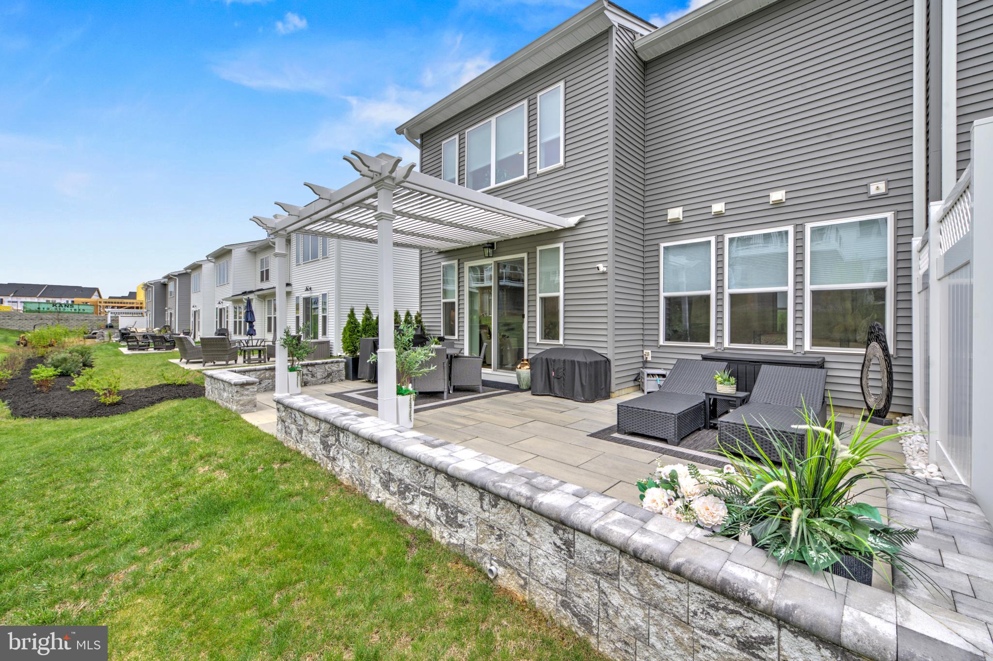 Motivated Seller! Why wait for new construction when this beautiful, "almost new" home , loaded with upgrades, is available right now?!  An extraordinary expanded townhome in the highly sought after Preserve At Marsh Creek 55+ community has just come to market- and it truly shows better than a model home. This stunning 3 bedroom, 2.5 bathroom corner property offers luxury, comfort and resort-style living at its finest.
Step into the grand foyer and immediately feel the elegance of gleaming oak hardwood floors that flow seamlessly throughout the main level. The modern open concept design features an expanded great room with a dramatic two-story vaulted ceiling, an enclosed gas fireplace, recessed lighting and an impressive wall of windows dressed in custom draperies. Sunlight pours in, creating a warm and inviting atmosphere. Sliding glass doors lead to an expansive stone patio with a paver wall, custom pergola and privacy fencing- the perfect outdoor retreat for barbecues, family gatherings or simply relaxing with a book and soaking up the sun.
The upgraded chef's kitchen is a showstopper, offering stacked wall cabinets with enhanced crown molding, a full custom tile backsplash, a large island that comfortably sits four, Whirlpool appliances,  a built-in wall oven and microwave and a spacious pantry. The adjacent dining area is ideal for both everyday meals and more formal entertaining.
The first floor primary suite feels like a private spa. Enjoy a sophisticated tray ceiling, a beautiful wall of windows and a luxurious ensuite ceramic tiled bathroom featuring a double vanity with upgraded cabinetry, elegant lighting and an oversized shower with bench seating.  A  large walk-in closet completes this serene retreat. A discreetly located powder room, laundry room and a two car garage with epoxy floor round out the main level.
The second floor offers a beautifully appointed loft- ideal as a living room, office or creative space, (currently being used as a family room and home office.).  Additionally, there are  two generously sized bedrooms featuring plush carpeting, recessed lighting and lots of closet space.  The full bath mirrors the home's refined aesthetic with a double vanity, upgraded cabinetry and designer fixtures.  A custom theater/game room adds a unique touch of luxury and entertainment and can be converted to a storage room, making this home truly one-of-a-kind.
INCLUDED in the sale of this home in "as is" condition and at no monetary value - LG refrigerator/freezer in kitchen (one yr. old), all outdoor wicker patio furniture, outdoor rug, cushion box and cushions inside, (BBQ grill and fire pit not included), brown leather couch in living room, both the mounted TV and the yellow couches in the loft as well as all clocks in the loft and the bedroom furniture in the blue bedroom (with the exception of the bed. )  
The BBQ  grill, fire pit, washer and dryer, dining room table and hutch, primary bedroom furniture- 2 night stands, bed frame, chest of drawers, garage storage units , cinema room contents except chair and monitor. are available for sale and are negotiable. 

Beyond the home itself, the Preserve At Marsh Creek offers an unparalleled lifestyle. The resort-style clubhouse invites you to unwind and connect. Enjoy the refreshing pool, pickleball courts, fitness center, yoga studio, card room and vibrant social calendar. Every day feels like a vacation! 
You have earned the right to live beautifully. Welcome to a home where luxury, comfort and community come together in perfect harmony.  The  Preserve At Marsh Creek- you may never want to leave home again!