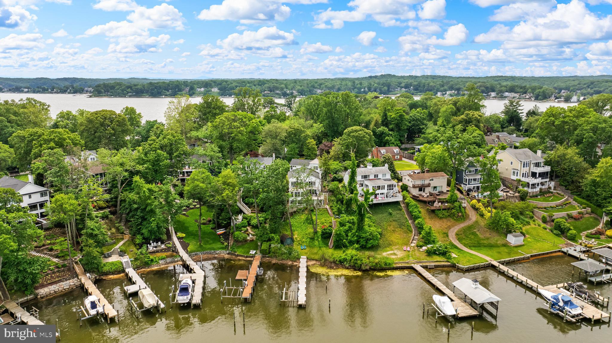 Welcome to a rare waterfront retreat tucked away in a secluded, wooded cove in the highly sought-after Linstead community, in the heart of Severna Park. Perfectly blending timeless coastal elegance with modern luxury, this exceptional residence offers breathtaking water views from nearly every room and an unparalleled lifestyle on the Severn River.
Originally renovated in 2014 and thoughtfully expanded and enhanced in 2017, the home was designed to maximize comfort and connection to the surrounding waterfront. From the moment you step through the front door, you are greeted by sweeping panoramic views of the water, creating an immediate sense of tranquility and escape.
The entry landing opens to an expansive, light-filled living room with walls of windows and access to a private waterfront deck—an ideal setting for morning coffee or evening sunsets. Adjacent to the living area, the gourmet white kitchen seamlessly flows into the sun-drenched dining room, a stunning owner-designed addition that beautifully combines style, functionality, and captivating views.
Also on this level is one of the home’s three bedrooms, complete with an en-suite bath, generous closet space, and convenient access to the laundry area.
Just a few steps above, the second level features an inviting waterfront sitting area with a balcony overlooking the cove, echoing the dramatic scale and openness of the living room below. The luxurious primary suite serves as a private sanctuary, offering its own waterfront deck, walk-in closet, and spa-inspired en-suite bath. An additional spacious bedroom and beautifully appointed full bath complete this level.
The top-floor expansion introduces two versatile bonus rooms—one showcasing stunning water views and the other featuring a private balcony retreat. A stylish half bath completes the space, making it ideal for a home office, artist’s studio, fitness area, or guest accommodations.
Outdoor living is equally impressive. Beneath the main level, a covered waterfront patio creates the perfect backdrop for al fresco dining and entertaining, with ample overflow space for larger gatherings. A reimagined storage area offers endless possibilities for a home gym, recreation room, or custom entertainment space.
From every level of the home and patio, the landscape gently cascades toward the shoreline, framing serene water views at every turn. In 2024, the owners completed extensive shoreline and structural improvements, including the installation of state-of-the-art sediment control fabric, new seeding for erosion management, and a foundation anchoring system designed to preserve the integrity and beauty of this remarkable waterfront setting for years to come.
Completing the property’s exceptional amenities are direct water access for swimming and kayaking, an outdoor shower, a 100-foot pier, and a powered vertical boat lift—offering effortless enjoyment of the Chesapeake lifestyle.
Located in the prestigious Linstead neighborhood, this extraordinary home provides convenient access to the Severn River, top-rated Severna Park schools, and the very best of waterfront living. Whether enjoying sunrise coffee from your private balcony or unwinding with sunset views across the cove, this residence offers a rare opportunity to experience luxury waterfront living at its finest.
A truly exceptional offering—schedule your private tour today.