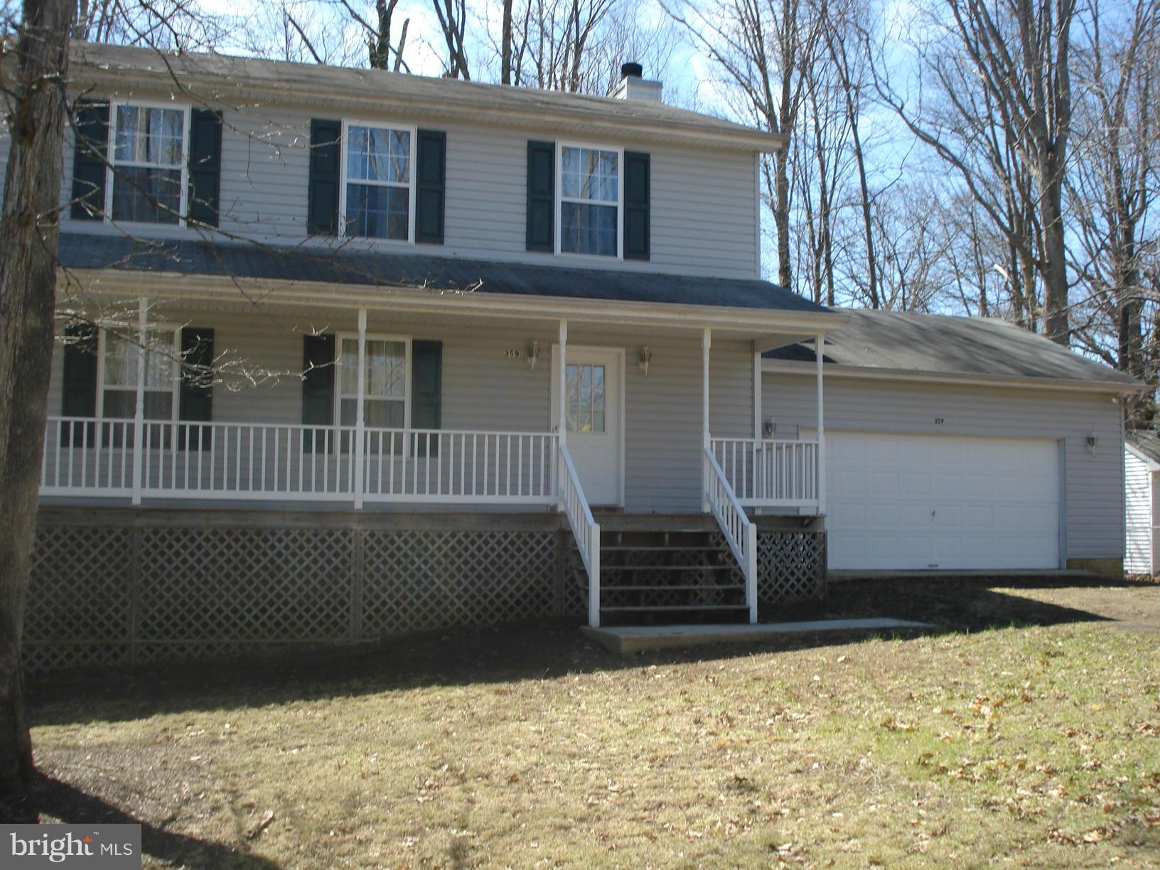 LOTS of room in this house! From the formal living room, dining room, family room with woodburning fireplace, 4 spacious bedrooms upstairs and a completely finished basement with it's own full bath!  For a total of 4 bedrooms, 3.5 baths.  Deck on the back overlooking the LEVEL back yard, covered front porch and oversized 2 car garage.  On paved road near lake beach.