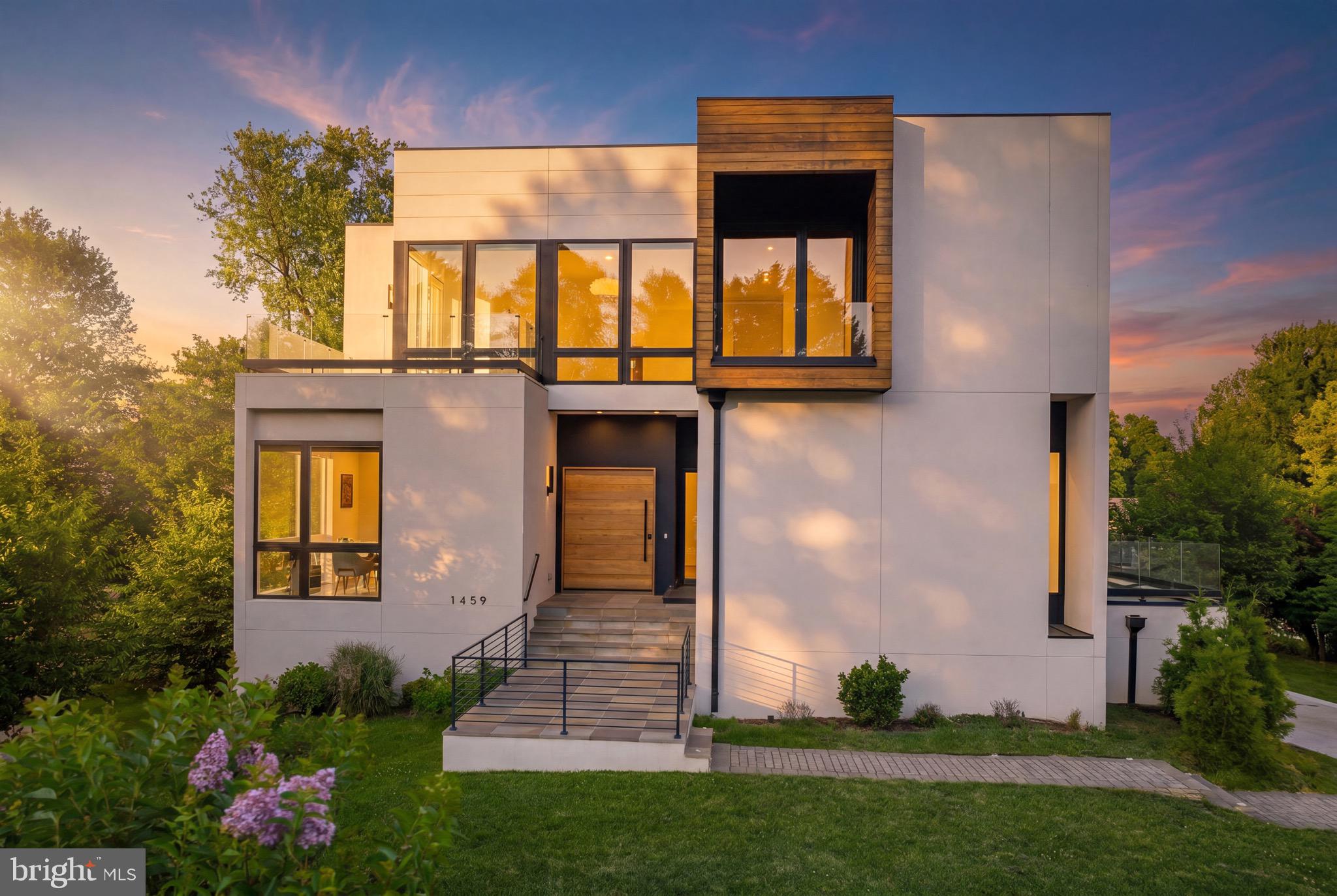 Introducing The Dewberry Modern — a true contemporary residence built in 2022 and meticulously maintained to rival new construction. Presenting a rare opportunity to own one of McLean’s few contemporary homes under $3M and priced below appraised value. Located in Broyhill McLean Estates off of a quiet cul-de-sac, this home is moments from Tysons, Washington DC, premier shopping, dining, and major commuter routes.
Defined by clean architectural lines, dramatic scale, and thoughtfully designed living spaces, this move-in ready residence features soaring 11’4” ceilings on the main level, 10’ ceilings throughout the upper levels, and floor-to-ceiling windows that flood the home with natural light. Hardwood and ceramic flooring extend throughout the residence alongside multiple outdoor living spaces, including private terraces off secondary bedrooms.
Every bedroom is designed with its own en suite bathroom and walk-in closet, creating privacy and flexibility for multigenerational living, guests, or extended stays. The main level features a sunlit private office, spacious first-floor bedroom suite with private terrace access, and a dramatic floating staircase accented by custom designer lighting spanning all levels of the home.
At the center of the residence is a sleek contemporary kitchen featuring custom cabinetry, Miele and Liebherr appliances, and integrated gas burners built directly into the countertops for a clean architectural finish. An elevator services all levels for convenience and accessibility.
The upper level is anchored by an expansive primary suite with fireplace, heated bathroom floors, custom blackout shades, and a spa-inspired bath. Additional en suite bedrooms, private terraces, and a spacious loft create flexible living and entertaining spaces throughout.
The lower level was designed for entertaining and lifestyle flexibility with a large recreation space, built-in wet bar with refrigerator and seating area, plus additional en suite rooms ideal for a fitness studio, theater, guest accommodations, or creative flex space.
An oversized three-car garage, turnkey condition, and true contemporary design make The Dewberry Modern a rare offering in today’s McLean market. Why wait for new construction when this residence is ready for immediate occupancy.