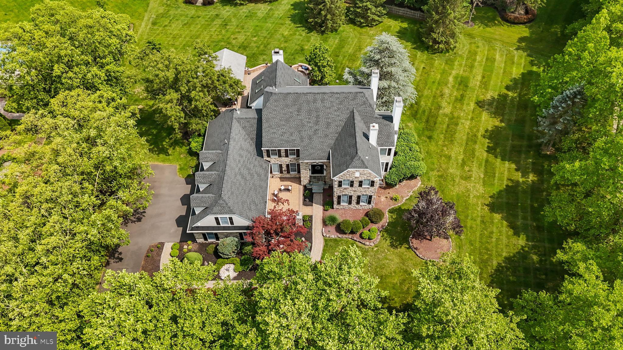 OFFER DEADLINE 10/20/25 10am.  A morning walk around your beautiful neighborhood, past the farmhouse and pond, under established tree canopies, using the extensive sidewalk system…. or your evening bike ride to Hansell Park or Bush Park…. all options for you when you live at this magnificent home in the highly desirable community of Oakleigh Farm in Buckingham Township, Doylestown PA.  Customized, updated and ready for the next lucky owners, this home features smart floorplan selections that will delight you throughout.  A special inclusion at this home is the main level en-suite bedroom, which is gracious in size with a large closet, a full bathroom, and sliding doors to the deck.  The large kitchen with granite counters, stainless steel appliances, five burner gas cooktop, two wall ovens, and tons of cabinets, flows into the inviting family room.  There you can spend important relaxation time using the wood burning fireplace with blower and take in the views of the side and back yards.  With the laundry room now on the second floor, its original space has become a terrific walk-in pantry – so functional!  A private office with wet bar has views of the front yard through handsome plantation shutters, and the back yard can be viewed from two Trex decks that overlook the large, flat, open lot.  Both the living room with gas fireplace and dining room offer space for their traditional uses, yet can become areas for homework, music, reading… your imagination is your guide here!  The second floor has been reconfigured so all rooms are accessible from the main and back staircases, which created a cozy loft area and second floor laundry room too.  The primary bedroom offers a sitting room with gas fireplace, new bathroom with heated floors, large tile shower, soaker tub, two sinks, storage with hidden electric / USB ports, walk-in closet with built-in storge plus two wall closets.  One additional en-suite bedroom with full bathroom, two additional bedrooms (one with direct access to the contiguous hall bathroom), and one updated hall bathroom offer great spaces for rest and work.  The finished basement is anchored by the custom hand-milled black oak bartop with space for seating, the stone wall, and a barn door separating the family room zone from the home gym zone.  A game room and storage area are also available.  This beautiful 1.02 acre lot includes a custom-built pavilion featuring infrared heaters in the ceiling and a built-in gas grill, a firepit area, and shed.  The side entry three-car garage is just what you would expect in a home of this caliber.  Extensive millwork throughout the home adds a layer of elegance.  Notable updates include roof, 4 skylights in family room, primary bathroom complete renovation, connected second floor with new loft and laundry room, new half bathroom vanity, mudroom shiplap, new interior doors, and exterior material update.  All of this plus Central Bucks School District, access to major highways and public transportation, proximity to highly ranked museums, shopping, dining, and state/local parks.  How exciting for the lucky next owners!