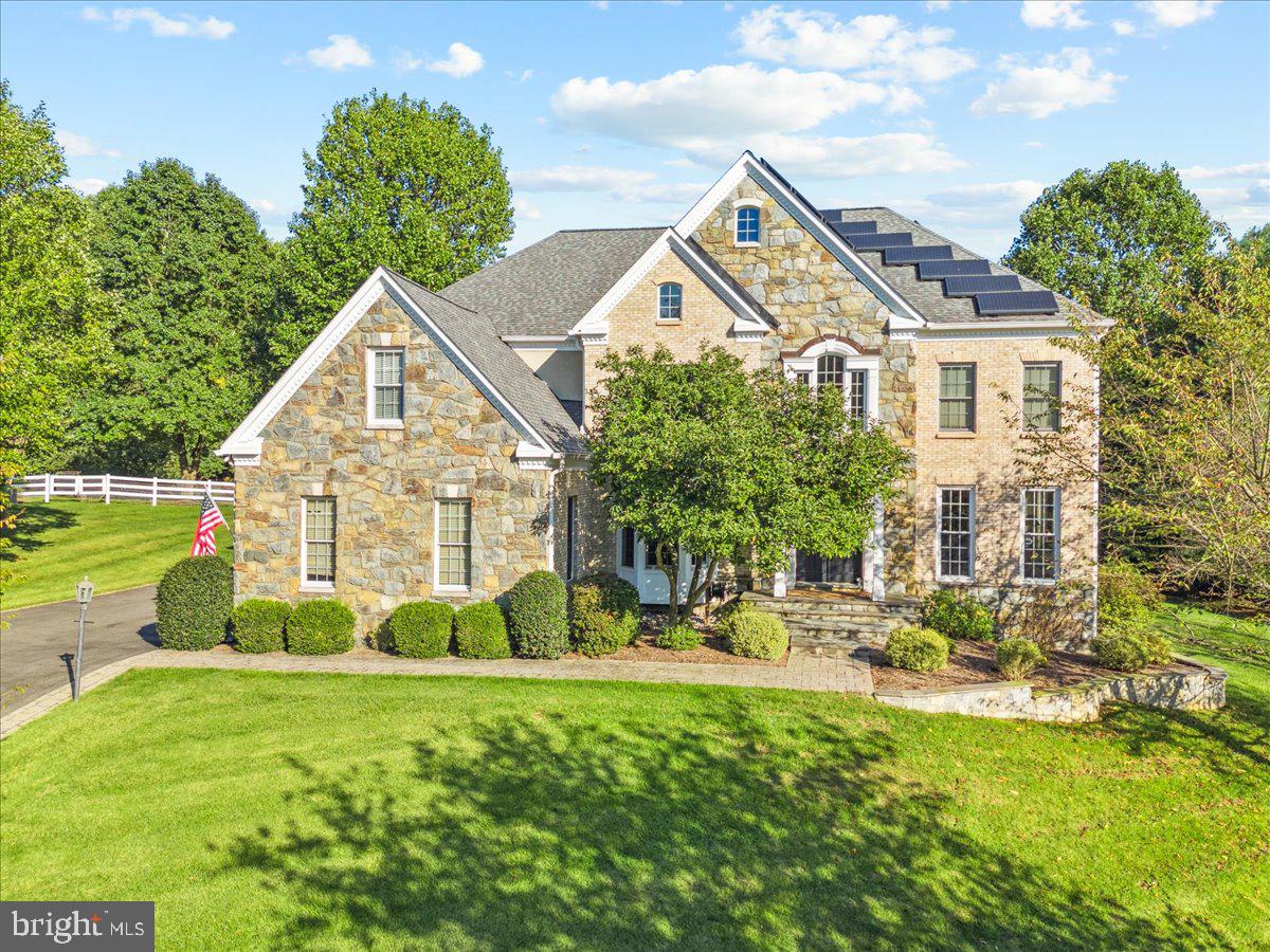 Down Doe Ln, to the end of the cul-de-sac is a stately and welcomed surprise. One of the largest homes in Rollinmead, thoughtfully sited on almost two acres, with a new in-ground pool, perfectly set-back in the rear of the yard, sits your dream home. As you approach, you immediately notice the shear size of the home, stunning front stone work and great elevation. Mature trees create a private, retreat-like feel on the property. As you enter, you are greeted by a soaring two-story foyer with refinished hardwood floors on the entire main level. The kitchen is the heart of the home with an expansive island, with new quartz countertops, in-set six burner cooktop, high-end appliances, ample cabinets, pantry and eat-in area. The eat-in kitchen area looks out beautifully to your rear yard and is engulfed by windows. The kitchen flows seamlessly into the family room. The family room is flanked by a stone fireplace with gas logs and is the ideal place to gather. Adjacent to the family room is a cozy "homework room" or "study nook." Off the family room is a generously proportioned dining room perfect for the formal gathering or special occasion. The main level also features a stunning sitting room/living room and large home office. The upstairs bedroom level has five bedrooms and three full baths. The primary suite is massive, with tray ceilings, a plethora of windows, en-suite bath with double vanities, large shower and infrared sauna. The primary bedroom also has a massive walk-in closet with closet organizer. There are four additional bedrooms on the upper level, three with new carpet. The second bedroom is also en-suite and expansive. The upper right side of the home has two additional bedrooms with a jack and jill bath. The fifth bedroom is adjacent to the laundry room. The lower level is lovely with a walk-out to the back yard and almost 2000 finished square feet. There is a potential theatre room, rec area with pool table and full bathroom with guest room. Additional features include an over-sized three car garage, extensive hardscaping, long driveway and more. Undoubtedly, the most exceptional part of the home is the new pool, set back beautifully in the rear yard, with extensive pavers, fully fenced and perfect for entertaining. If you've been dreaming of a home that affords you all the luxuries you've ever desired, look no further. Over 7000 finished square feet on almost two acres in the heart of Montgomery County is hard to replicate. Enjoy close proximity to Shady Grove Metro, Trader Joes, Harris Teeter, Lakewood Country Club, Muddy Branch Park and Quince Orchard. Welcome home!