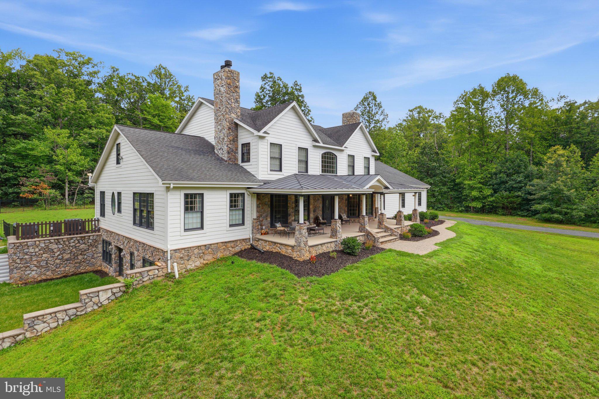 This custom-built home is nestled in over 21 wooded acres within a short drive to several wineries, quaint shops and national parks. This home includes over 7500 finished square feet, an oversized three car garage, large front porch, outdoor patios, swimming pool, wooded trails, a stream, and loads of peaceful privacy. Main level features hardwood flooring, two staircases, main level master, formal living room and dining room, two fireplaces, family room, open concept kitchen with granite and stainless steel appliances, two additional offices/flex rooms, and large laundry room. Upper level has four additional oversized rooms, Jack and Jill bathroom, a large hall bath with double vanity and separate shower area, plus a rare upper level bonus room. Lower level impresses with a rec room worthy of entertaining, a large wet bar with quartz countertops, an in-law suite, full bath, game room, home theater, home gym, and access to additional outdoor area for entertaining. This one-of-a-kind home is only 15 minutes from Warrenton and perfectly between Washington, DC and the scenic beauty Virginia has to offer.