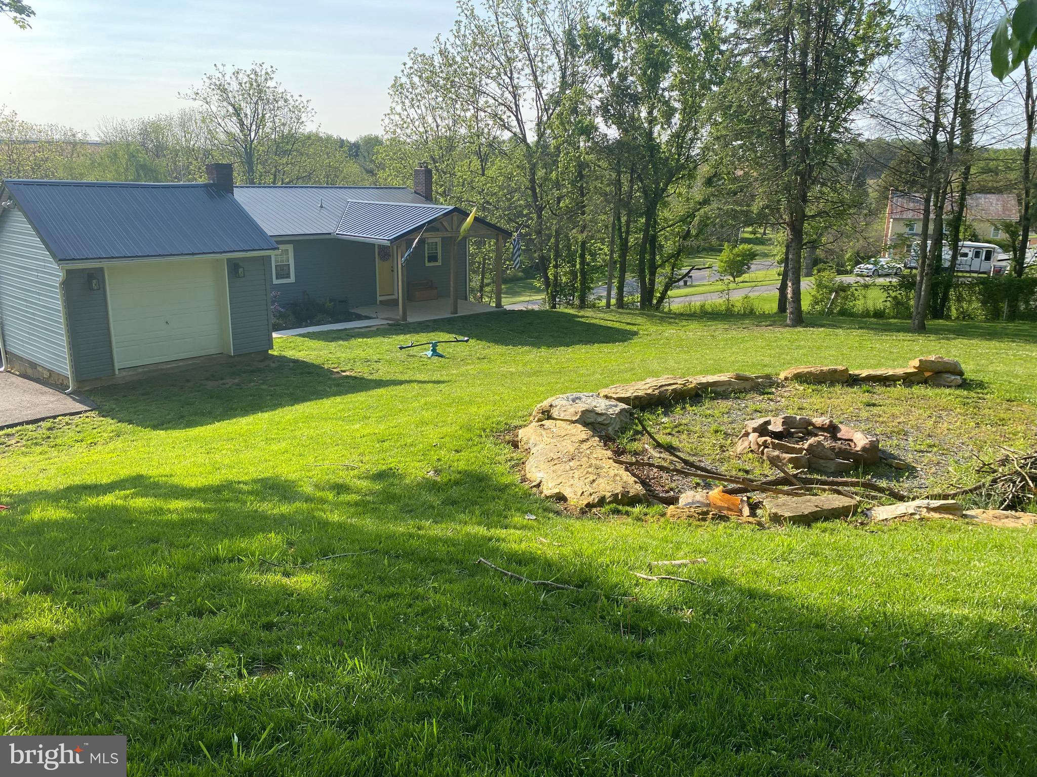 The view is wonderful and so much to offer in this open concept, adorable home on 1.22 acres. Privacy with convenience, you can't ask for more! This home was renovated in 2021 with new roof, siding, windows, appliances, island, counter tops of granite, bathrooms, doors and a high efficiency multi-zone heat pump and a hot water heater!!! On the lower level,  a wet bar with a mini fridge, primary bedroom, living area and a walk out. Perfect for an in law suite, guests, rental or just more room for entertaining!                                                          ****BACK ON MARKET BECAUSE BUYERS FINANCING FELL THROUGH****                                                                                ***SELLERS are giving a BONUS of snow removal for the entire first year to BUYERS . It will be added to the contract.