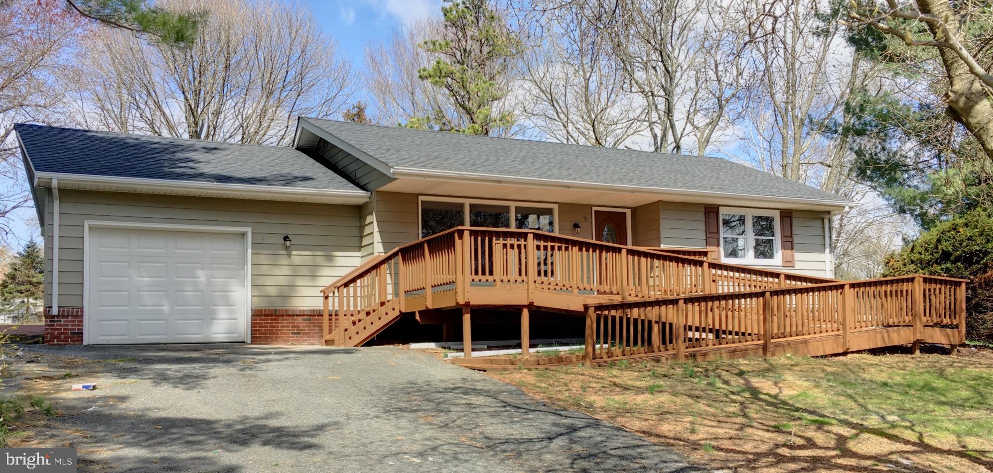 Check out this freshly rehabbed property - ready for your family to call home! Not far from Fair Hill, and situated on almost a full acre, you can enjoy (mostly) one level living, with everything except the garage on the same floor. Entertain in the all new kitchen, complete with granite counters and stainless appliances. Huge yard with mature trees provides plenty of space to enjoy the outdoors, and for kids (or pets) to run and play. Awesome bonus sunroom/office with vaulted ceilings, skylights, and panoramic windows to bring the outdoors in. Relax in the large master suite, complete with walk in closet, large private bath, vaulted ceilings, and private French doors leading to the back yard. Oversized garage provides both parking for your car and extra space for work area or storage.  Ramps in both the front and rear of this property make it accessible to the entire family. Plus - the seller will include a one year home warranty!  This one won't last long, see it today!