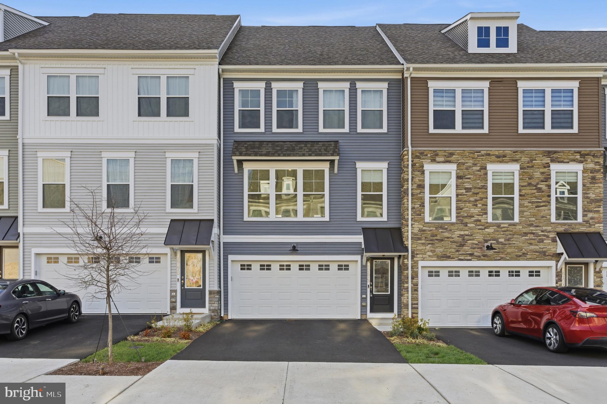 Welcome home to this near brand-new townhome in Loudoun County!  Nestled on a premium east-facing lot and built in 2025, this stunning 3 bedroom 3.5 bathroom home spans over 2250 square feet and has everything you've been looking for.  As you pull up, you'll love the crisp curb appeal, and the fun begins the moment you walk into this move-in-ready home.  The main level boasts an open floor plan bathed in natural light and is highlighted by a beautiful white gourmet kitchen with a center island, double oven, large single sink, and tons of cabinet space.  This flows perfectly into a lovely dining space on one side, and a spacious main living area on the other!  Plenty of room for furniture, decorations, and easy access to a high-end Trex deck overlooking the greenery only visible from a few premium lots in the neighborhood. Upstairs you'll find 3 bedrooms and 2 full bathrooms, including a primary suite with a gorgeous bathroom and oversized walk-in closet!  Upstairs laundry as well, which is essential!  The lower level is home to an open recreation space, bonus nook, full bathroom, and accesses the fantastic 2 car garage equipped with an EV outlet!  From this level you can also walk-out onto a quaint stone patio and into your own quiet yard space. The icing on the cake is the location - you're just minutes from the fully loaded Dulles Landing Shopping Center, South Riding Market Square, Brambleton Town Center, and everything else that Loudoun County has to offer. This one truly has it all, so be sure to come see it for yourself!
