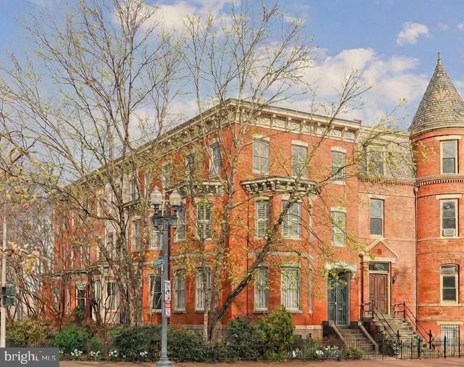 Logan Circle Grande Dame. 

Straight out of the Gilded Age, this extraordinary circa-1890 residence commands a premier position overlooking vibrant Logan Circle. With two dramatic walls of bay windows and coveted southwestern exposure, the home is bathed in natural light while offering picturesque park views and an unmatched connection to one of Washington’s most iconic neighborhoods. Inside, timeless architectural details abound—soaring 11-foot ceilings, rich hardwood floors, intricate custom millwork, and two magnificent fireplaces with exquisite mantelpieces create a sense of grandeur rarely found today. Expansive entertaining rooms balance historic elegance with warm everyday livability. The first upper level features a gracious primary suite with custom shutters and sweeping views of Logan Circle Park, a beautifully preserved bath with antique claw-foot tub, and a spacious second bedroom or family room anchored by its own fireplace. Upstairs, three additional bedrooms and a second full bath provide exceptional flexibility for family, guests, or home office needs. The fully finished lower level, complete with a private entrance, offers remarkable versatility with a living room, table-space kitchen, sixth bedroom with ensuite bath, and walk-out access to a secluded patio—ideal for, guests, in-laws, or private workspace. Outside, beautifully landscaped gardens and an expansive patio framed by a custom iron fence create an enchanting urban retreat perfect for entertaining or quiet relaxation.

A truly rare offering—one of Logan Circle’s last intact single-family Grande Dames, rich in history, architectural character, and vibrant city living.