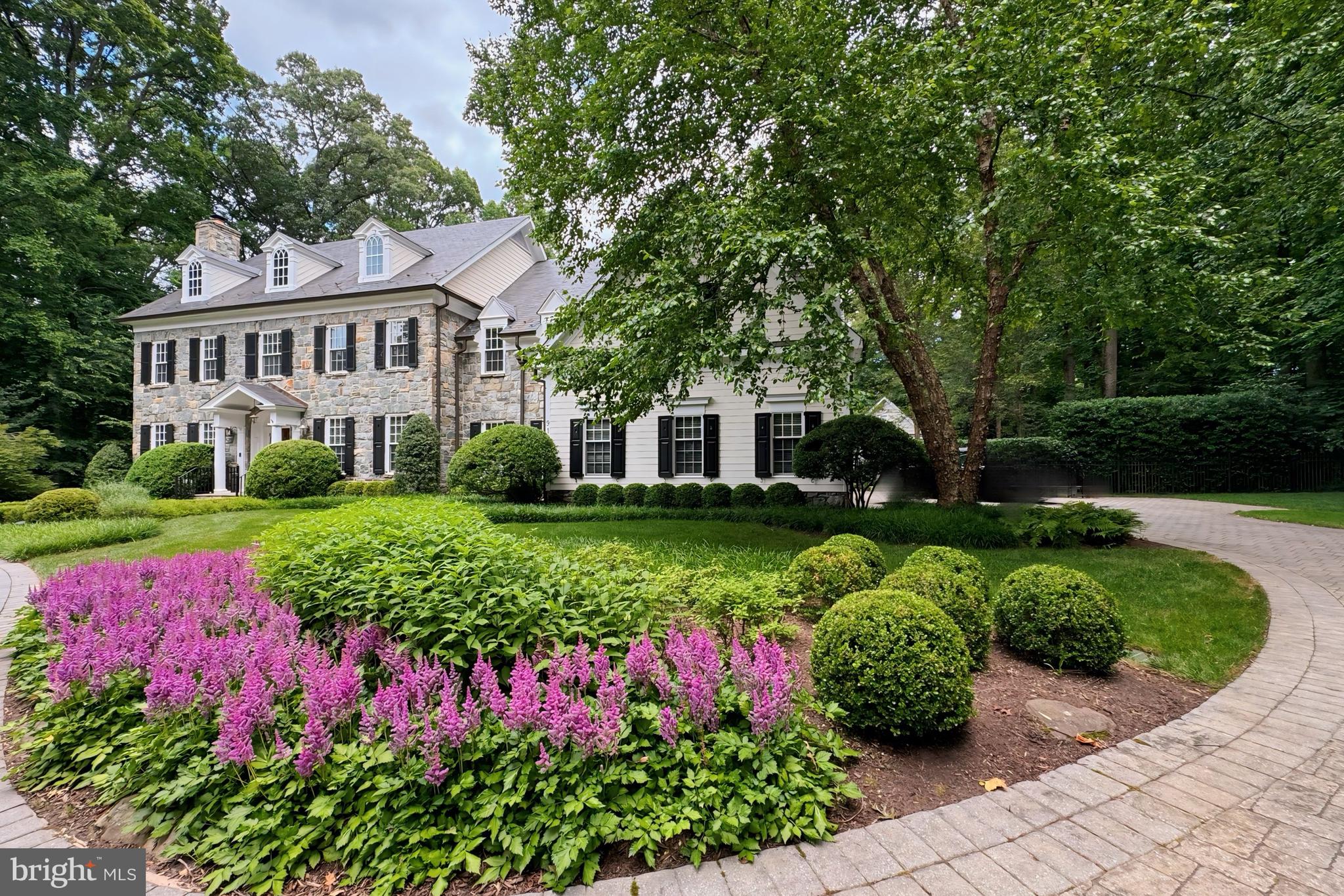 Quietly tucked in the serene landscape of The Reserve, this exceptional Stone and Siding English Manor Home, with a Slate Roof, stands as a testament to meticulous craftsmanship and luxurious living. Custom-built by Ted Visnic on a sprawling 2.17-acre double lot, this estate offers a rare opportunity, with ample space for a tennis court amidst meticulously manicured park-like grounds complete with a Pool featuring a  waterfall, Spa and Pond. Step inside to explore this thoughtfully designed elegant home, showcasing exquisite walnut floors, staircases, and fine wood paneling throughout. The main level invites with a grand Entry Hall leading to a Living Room featuring a Fireplace and a Dining Room with a spacious Butler’s Pantry. A wood-paneled Library offers a secluded space overlooking the gardens. The Chef’s Kitchen, equipped with top-of-the-line appliances and an 8-burner stove, centers around a large island and leads to an oversized Breakfast Room with panoramic views of the Pool and Pond, teeming with colorful fish. Family gatherings are accommodated in the generous Family Room, featuring floor-to-ceiling windows and a high coffered ceiling. An Elevator off the Mud Room stops on all 3 levels. The Owner’s Suite on the Upper Level includes a separate sitting room, a coffee bar with refrigerator drawers, a lavish bath with heated floors, separate vanities, and double walk-in closets. The Second Level also hosts four additional bedrooms and three baths, while the Third Level offers two bedrooms and a bath. The Lower Level is an entertainment haven, featuring a Fitness Room, Home Theater, Billiards Room, Wet Bar, Custom Wine Cellar, and a Bath with a Steam Shower. Outside, a circular heated driveway ensures snow melt, leading to a generous garage equipped with a Tesla 80AMPS charger. An outdoor pool bath with storage complements the pool, which is operational even during power outages thanks to the whole-house generator. This remarkable property combines unparalleled craftsmanship with extraordinary amenities, offering a lifestyle of luxury and comfort in a private, idyllic setting.