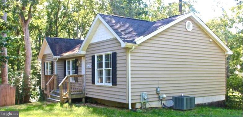 Tucked away treasure!  This home shines like new and is in a peacefully tree lined setting.  The main level offers updated flooring and paint. 3 good sized bedrooms. The lower level offers a walk out and offers a large living space that could be finished or for great storage. Come take a look and make this home yours for less than rent!