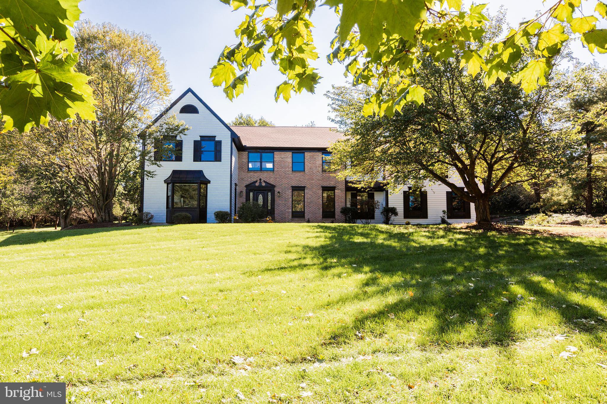 Some homes check the boxes. Others change the way you live.
Hidden among mature trees in one of Lancaster Township's most desirable locations, this beautifully crafted custom home offers an uncommon combination of privacy, architectural character, and timeless design.
From the moment you arrive, the winding approach and established landscape create a sense of arrival rarely found so close to Lancaster's restaurants, healthcare, and commuter routes.

Designed to bring the outdoors in, the home is filled with natural light, soaring ceilings, and thoughtfully framed views of the surrounding landscape. The dramatic great room is anchored by a striking floor-to-ceiling brick fireplace, while oversized windows and skylights create an inviting atmosphere throughout every season. Warm hardwood floors, custom built-ins, and carefully curated finishes balance timeless character with modern comfort.
A unique feature of the home is the two spacious primary suites, one on the first floor, the other on the second. The first floor suite features its own access from outside, and at 550 square feet (the size of a small apartment) it can function as its own home within the home, featuring a spa-like bath with a large soaking tub, its own kitchenette, and living space. This makes the home uniquely suited for multi-generational living, or for aging in place.
The home's flowing layout is equally suited for quiet evenings by the fireplace, hosting holiday gatherings, or opening the doors to outdoor entertaining as the backyard becomes an extension of the living space. Every room was designed to feel connected to the property's natural beauty, creating a sense of calm that's increasingly difficult to find.

Outside, the grounds provide exceptional privacy with plenty of room to garden, play, relax, or simply enjoy the peaceful surroundings. Whether sipping coffee while watching the morning light filter through the mature trees or gathering friends for an evening under the stars, this property offers a lifestyle that feels worlds away from the everyday.
Want to try your hand at homesteading? The grounds include an established orchard with peach, cherry, and apple trees, as well as berry patches and a highly productive garden.
The home has undergone a near complete renovation since 2020, including a new roof, new HVAC, all four bathrooms are either new or had a complete makeover, all new flooring and paint, and a kitchen makeover. 
The newly finished lower level provides generous additional living space perfect for recreation, fitness, media, or hobbies, while the home's five bedrooms offer flexibility for family, guests, or remote work.

Homes that combine this level of privacy, architectural character, and location rarely become available. This is more than a place to live-it's a place to slow down, gather well, and enjoy the best that Lancaster has to offer. Don't miss the opportunity!