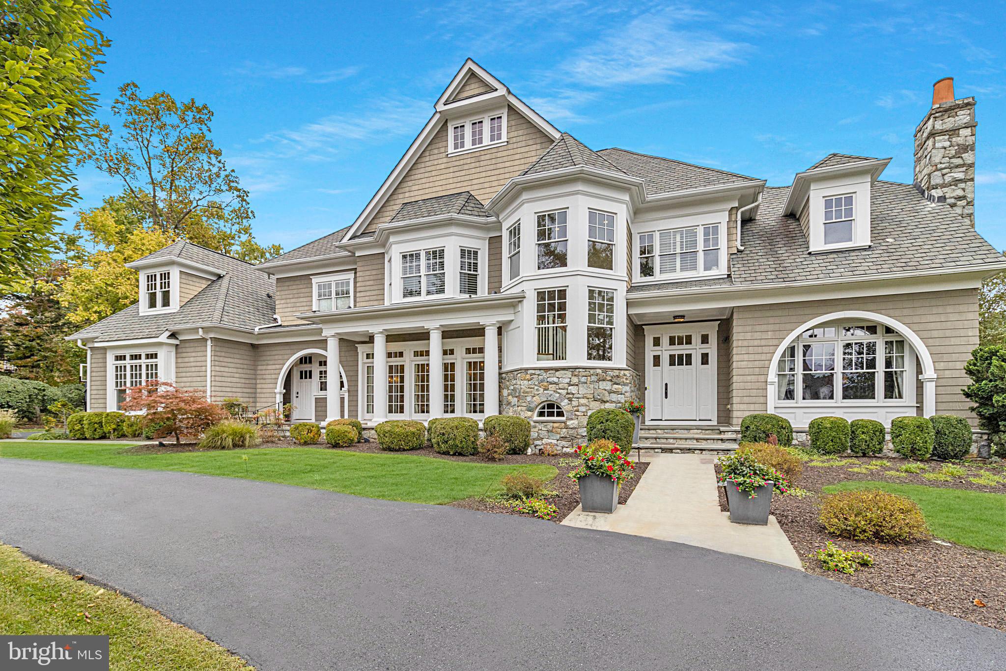 Rare opportunity to own this luxurious newer stone and shingle masterpiece designed by renowned architect Glenn Fong and built by Augustine Builders, situated on a gorgeous one-acre lot, only 1.5 blocks from Potomac Village.  The extraordinary outdoor living spaces include spectacular heated pool with waterfall, pool house with delightful summer kitchen and covered porch plus additional full bath. You'll love the putting green, firepit, expansive patio, and additional screened porch!  Beautifully maintained and updated throughout including gourmet kitchen, fabulous great room, huge formal living and dining rooms, study and expanded laundry/mud room. The upper level features a dramatic primary suite with modern, luxurious four-piece bath and dual spacious walk-in closets, as well as four additional bedrooms, each with adjoining bath. The fully finished lower level offers theater, gym, wine cellar, and an additional bedroom and full bath. You'll find high ceilings and topnotch designer features throughout. Four-car garage parking.