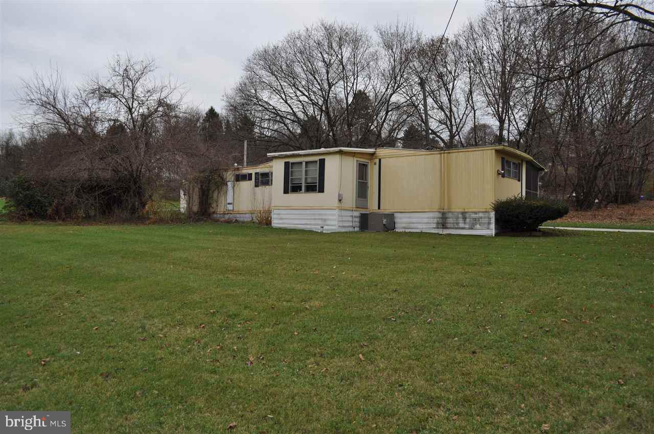 Mobile home situated on 2 parcels  consisting of a total of .5060 of an acre being sold as a package.  Great opportunity for a handy man.  Mobile on one parcel and garage on second parcel.  Public water and public sewer.