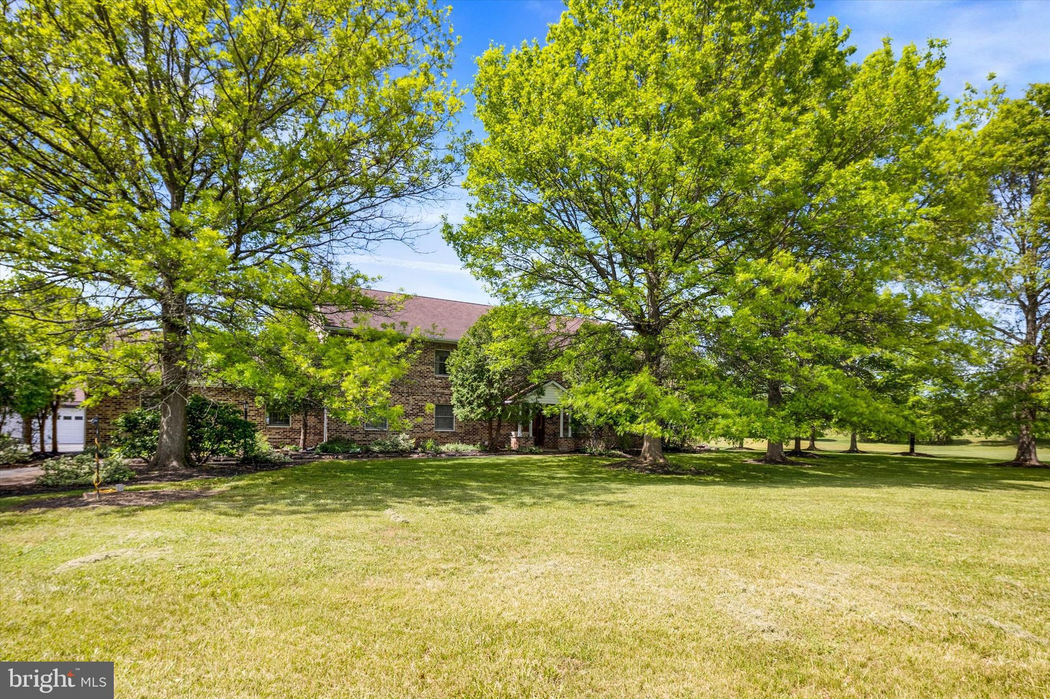 Coming soon! This beautiful brick home is ideally situated on an expansive 2.86 acres in Douglassville and boasts over 5,000 square feet, 4 bedrooms, 3.5 baths, a huge office, an upstairs family room, a craft room,  and a spacious living room with a gorgeous floor-to-ceiling stone wood-burning fireplace. Throughout the house you will appreciate the solid oak woodwork, including the staircase, doors, and trim, as well as the roomy kitchen which has a long breakfast bar and plenty of space to fill a large farmhouse table with family and friends. In the bedrooms, you will find tons of closet space with the master bedroom suite boasting his and hers walk-in closets. There is also a convenient and sizable main floor laundry. With almost 4 acres, this home has endless possibilities. It has a covered back deck and is surrounded by a expansive yard with plenty of room for entertaining or play. It is also set far back from the road at the end of a long driveway that leads to the side entry garage, and to the detached garage which was used as a wood-working shop for many years and that has storage above. So call today to set up your showing to view this one of a kind home. A one-year home warranty is also included.