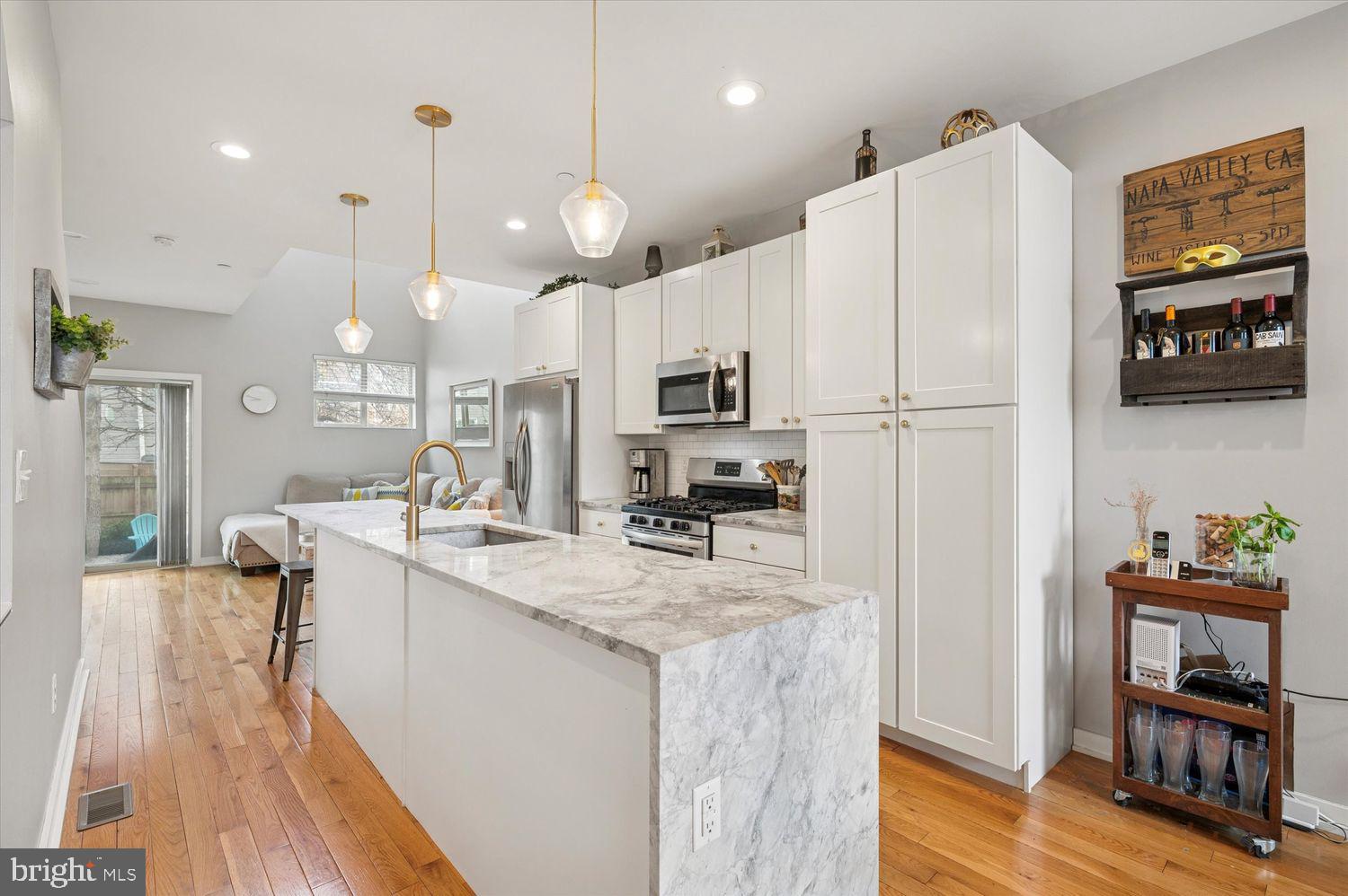 Welcome to 1933 E Cumberland, a stunning and thoughtfully designed rowhome that perfectly blends modern construction with timeless charm. Nestled in a quieter neighborhood yet just moments from the vibrant heart of Fishtown, this home offers the best of both worlds.

Step inside to an inviting open-concept floor plan featuring a spacious dining area, a sleek kitchen, and a living room with soaring vaulted ceilings. The kitchen is a chef’s dream, boasting a massive island, stainless steel appliances, and elegant white cabinetry. Expansive windows throughout the first floor flood the space with natural light, creating a warm and airy ambiance. Just beyond the living room, you'll find a true urban oasis—an oversized backyard perfect for fur babies or entertaining.

The second floor is dedicated to the luxurious primary suite, complete with a walk-in closet and a spa-like bathroom featuring double sinks and a glass-enclosed shower. A bright and airy landing on this level provides the perfect spot for a home office or reading nook.

Upstairs, the third floor hosts two generously sized bedrooms, each with ample closet space and large windows. A full bathroom and a convenient laundry room complete this level. Continue up to the expansive roof deck, where you’ll enjoy breathtaking views of Center City—ideal for unwinding or entertaining guests.

The fully finished basement adds even more versatility, offering additional living space and a full bathroom. With 4 years remaining on the tax abatement, this exceptional home truly has it all. Don’t miss your chance to make it yours!