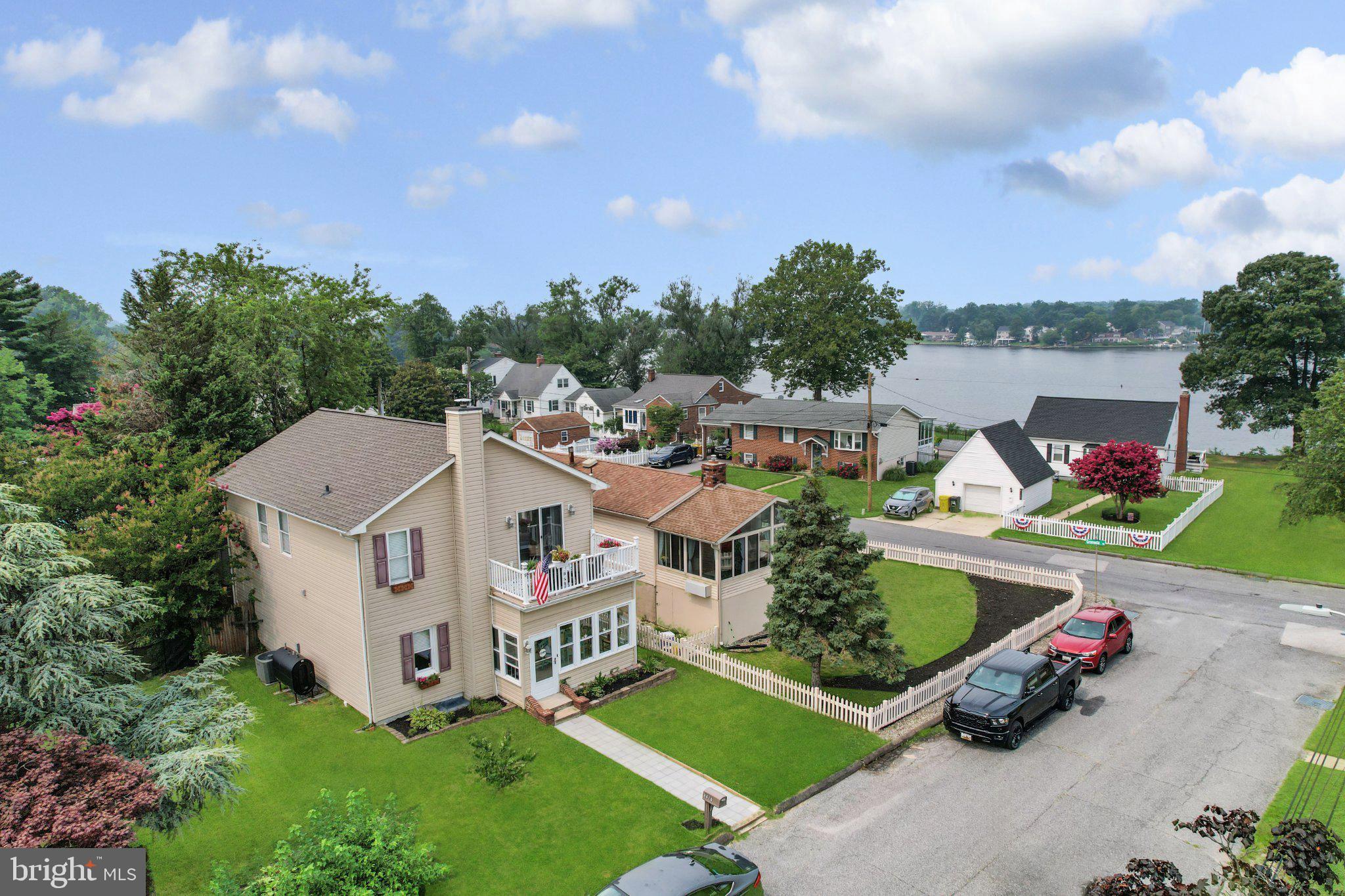 This charming and spacious colonial home in the desirable waterfront community of Sunset Beach offers a perfect blend of comfort and modern living throughout the three finished levels. The interior boasts a cozy enclosed front porch/sunroom, elegant crown moldings, and gleaming hardwood flooring. Enjoy the warmth of natural light in the traditional floor plan complimented by recessed lighting. The spacious eat-in kitchen has abundant cabinetry, a food prep island, and a breakfast bar for additional seating – a great space for entertaining. The main level features a conveniently located office/den or potential “4th” bedroom with an adjacent full bath. The upper level has three nice sized bedrooms, a full tiled hall bath and a super primary suite with an updated ensuite tiled bathroom and walk in closet. Also, off the primary suite, you can kick back and relax on the attached deck and enjoy your favorite beverage while taking in the gorgeous sunsets over the water! The lower level has a huge family room perfect for entertaining as well as a convenient ½ bath. The lot is level and fenced in the rear, ideal for outdoor gatherings. The rear lot also has a large shed for storage. The 2008 renovation ensures modern amenities while retaining classic charm – new architectural shingled roof in 2025 too! The voluntary association allows access to desirable waterfront community amenities including a beach for swimming, boat ramp, multiple piers/docks, and picnic area. These wonderful amenities give ideal access for boating, kayaking, stand up paddleboarding, fishing/crabbing and more! Enjoy the waterfront lifestyle of living near the shores of the Chesapeake Bay and all it has to offer.