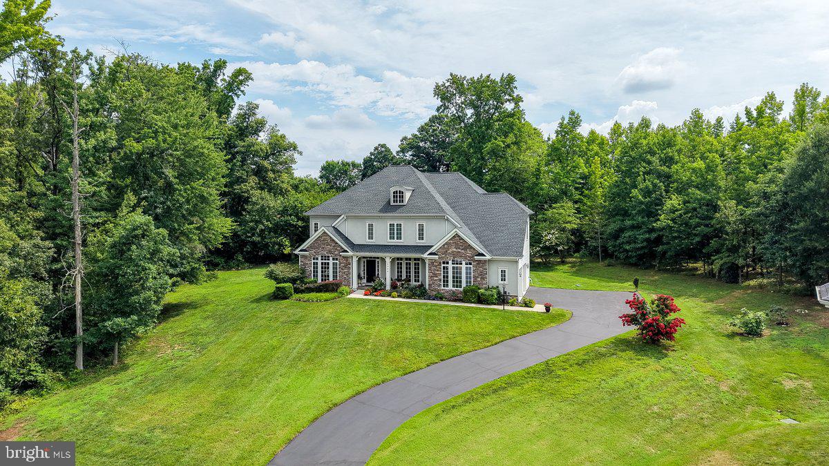 GRAND LIVING MEETS EXCEPTIONAL VALUE. 
 Set on an expansive homesite with sweeping side lawns and exceptional privacy, this home offers room to spread out without the maintenance of a heavily wooded backyard. The oversized side yard is perfect for soccer games, a future pool, outdoor entertaining, or simply enjoying wide-open green space. Unlike many homes in this price range, you’ll appreciate the feeling of openness and distance from neighboring homes.

Nestled in the prestigious Laurel Overlook community, this exquisite Colonial-style residence embodies the perfect blend of elegance and comfort. Built in 2010, this stunning home offers a spacious layout that invites you to experience a lifestyle of luxury and tranquility. As you step inside, you are greeted by an abundance of natural light that dances across the rich hardwood floors, creating a warm and inviting atmosphere. The thoughtfully designed floor plan features FIVE generously sized bedrooms and FOUR and a half bathrooms, ensuring ample space for both relaxation and entertainment. There are TWO additional rooms that could be used as a bedroom or office making this a potential SEVEN bedroom home.  Each room is a sanctuary, offering a perfect retreat at the end of the day. The heart of the home is undoubtedly the expansive living area, where a cozy fireplace serves as a focal point, perfect for gathering with loved ones during chilly evenings. The fully finished daylight basement, complete with an outside entrance, provides additional living space that can be tailored to your needs-whether it be a home theater, gym, or playroom. The gourmet kitchen is a chef's dream, equipped with high-end appliances and ample counter space, making it ideal for culinary creations and entertaining guests. Step outside to discover the serene outdoor space that surrounds this property. The nearly one-acre lot offers a private oasis, perfect for enjoying morning coffee or evening sunsets. The side-entry attached garage provides convenience and easy access, ensuring that your vehicles are sheltered and secure. This home is not just a residence; it's a lifestyle. The Laurel Overlook community offers a sense of exclusivity and tranquility, while still being conveniently located near local amenities. The Laurel Hill Golf Club,  Pohick Regional Bay Park,  The Workhouse Arts Center, Occoquan Regional Park, Mason Neck State Park and George Mason's Gunston Hall are nearby.  Ideally situated near Route 95 and Fairfax County Parkway, this home offers exceptional convenience for commuters and travelers alike. Enjoy seamless access to major transportation corridors, making daily commutes, weekend getaways, and trips throughout the Northern Virginia and D.C. region both efficient and stress-free.  Just minutes to Lidl, Giant, Laurel Hill Community Center, Workhouse Arts Center, INOVA Healthplex, and Fort Belvoir. Quick access to I-95, Route 123, Route 1, and the Fairfax County Parkway.  COMMUNITY POOL AVAILABLE NEARBY. Don't wait to make this extraordinary home yours - schedule a private tour today!
 Experience the perfect harmony of luxury and comfort in this exceptional home. Whether you are entertaining guests or enjoying a quiet evening by the fire, this property is designed to cater to your every need. Don't miss the opportunity to make this dream home your own.