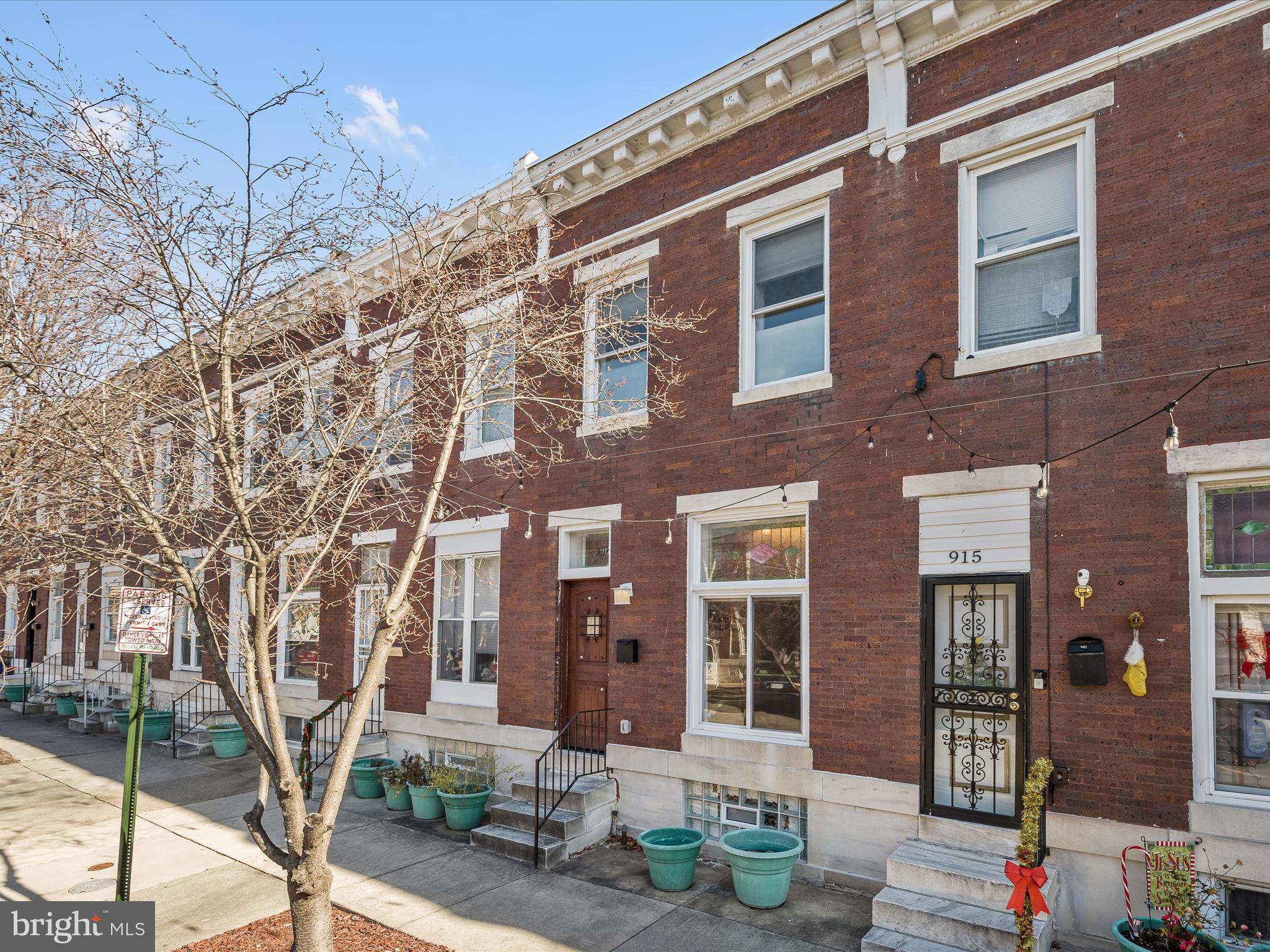 Welcome to your New Home where the magic of City urban living meets modern luxury. Step into a completed renovated 2-bedroom, 2-bathroom rowhome offering 2 bonus rooms (functional for a media room and home office) nestled in the vibrant heart of Baltimore City adjacent to John Hopkins Hospital. You'll find the home in pristine condition with exposed brick feature throughout, tiger wood flooring on the first level and a seamless open-concept design that invites you directly into the living room, featuring a beautiful, coffered ceiling, contemporary lighting fixtures, 4 recessed built-in picture art inserts, 2 lovely stained-glass transoms above the entrance door and oversized, front double window. Nestled in between the living room and the kitchen is a dining area with custom tray ceiling and lighting. Rounding off the main level the stunning new kitchen adored with beautiful granite countertops, black and white ceramic tile backsplash design, with white cabinets offering soft closure drawers, elongated ceramic tile flooring, built in microwave, 4 burner gas oven range, refrigerator w/ice maker, and gleaming stainless-steel appliances. There is a conveniently located rear security door from the kitchen to the rear patio fully fenced yard. Enjoy the custom-built ascending staircase with decorative posts, handrails and wood and iron balusters, leading to the beautiful upper level featuring a primary suite accented with a modern ceiling fan, glass-block feature wall allowing more natural light. The ascending wall boasts picture cut outs to feature artwork or collectibles. Escape to an oasis with the newly renovated and stunning full bathroom offering marble flooring and beautiful marble and elongated ceramic tilework throughout. The lower level is a completely finished basement with 2 bonus rooms with two closets for overnight guests, a rear security entrance door, stunning full bathroom with shower/tub combo. A washer and dryer are nestled in the laundry area and Extra storage is offered under the staircase. Enjoy the stunning lighting fixtures throughout the home accenting the modern design look. Private back yard for entertaining and BBQ's. Become part of an emerging and revitalizing community. Minutes from shops, restaurants, parks and downtown Baltimore. No Parking in front of the building Tuesday and Friday 8am-11am for street cleaning. If violated, vehicles will be towed. On the opposite side of the street, No Parking Thursday 8am-11am for street cleaning. If violated, vehicles will be towed. Head-In Angle Parking Only.  Seller is willing to hold financing at 9% for 3 years to buyers who can place at least 20% down. Buyers must then refinance after the 3 years. Terms will be negotiated according to the offer.