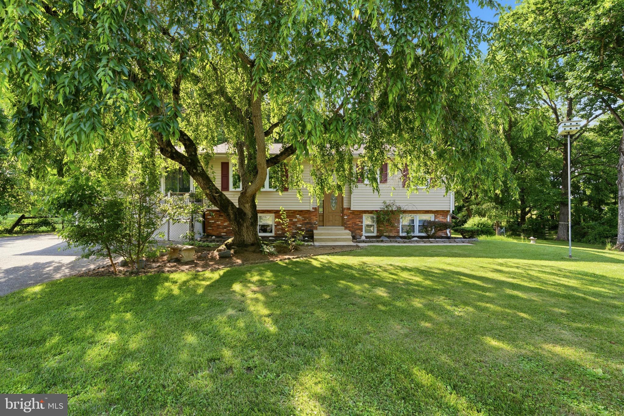 Move in ready so start packing! Situated on over an acre of land, this property offers the space and privacy you've been looking for. The expansive & level backyard is complemented by a massive barn/shed, providing endless possibilities for storage, hobbies, or workshop space. Inside, the updated eat-in kitchen features granite countertops, stainless steel appliances, and opens seamlessly to the family room, creating an ideal layout for everyday living and entertaining. A fully finished walkout basement adds valuable living space, while the sunroom and maintenance-free Trex deck provide the perfect spots to relax and enjoy peaceful backyard views. An oversized attached carport, paved driveway, and parking for up to seven vehicles complete this exceptional property. 100% financing approved, no downpayment program available. Welcome home!