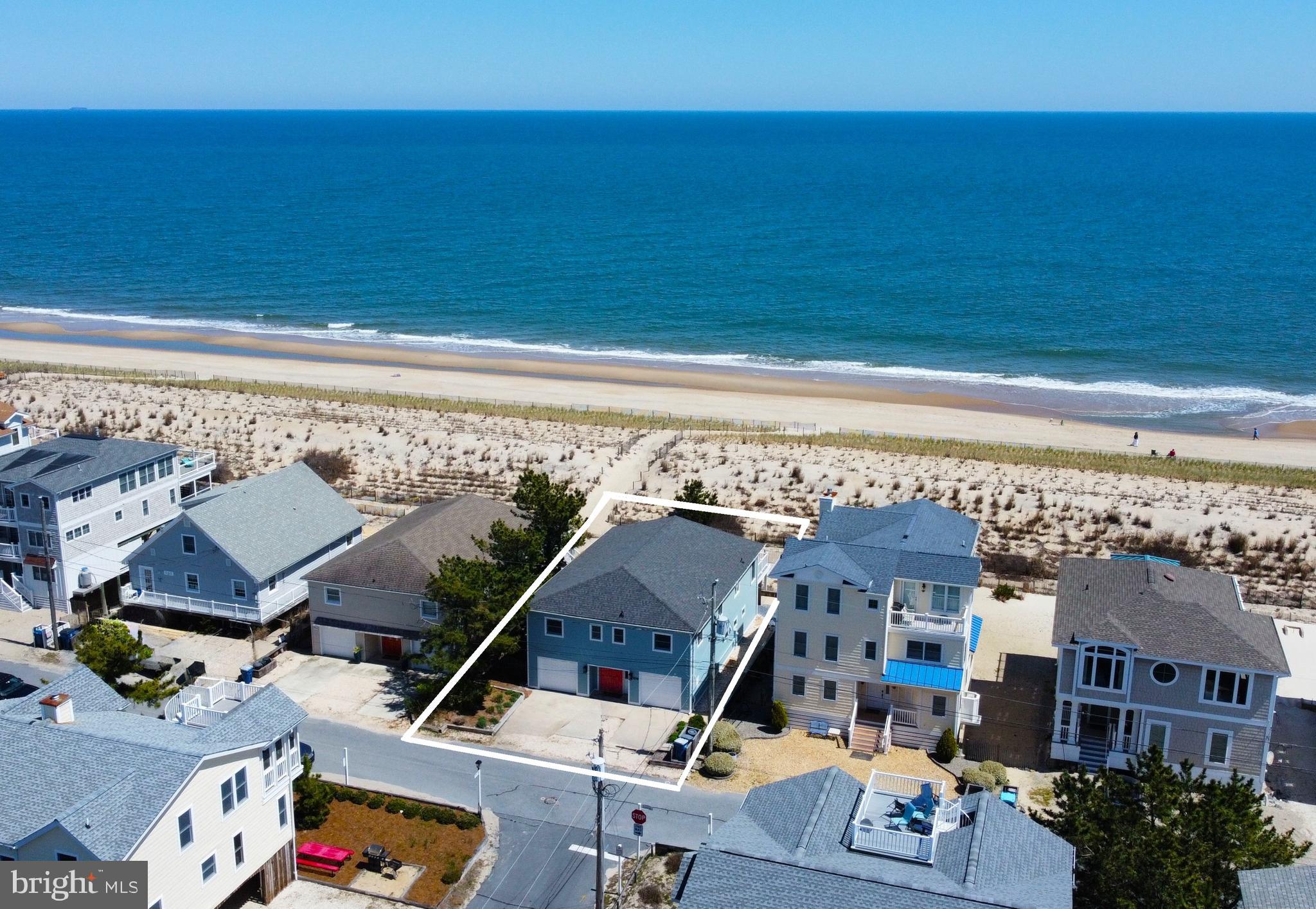 Oceanfront coastal cottage with expansive views of the coastline and access to a life-guarded beach, only steps from your deck! This home is full of seaside charm with soaring, exposed-beam wood ceilings and wide plank wood walls, painted a crisp white.  The wide open floor plan offers an abundance of space for family and friends to gather. The expansive great room with stunning ocean views spills onto an oversized beachfront deck.  Featuring 5 bedrooms and 3 full baths, this home has two additional areas to gather, especially on a rainy day at the beach.  The loft is the perfect spot for kids on the top floor, and on the ground level, there is a separate game area with a ping pong table and large screen TV.  The over-sized garage provides added parking and together with a second smaller garage, there is ample storage space for bikes and all your beach necessities. Automatic storm shutters on the East side of the home provide added security and peace of mind when you are away. Offered fully furnished, this property is ready to be enjoyed or would be an exceptional investment property with a strong rental history. Located in South Bethany, well known for its beautifully wide, uncrowded beach, and just a short drive to downtown Bethany with shops, restaurants, and a boardwalk.