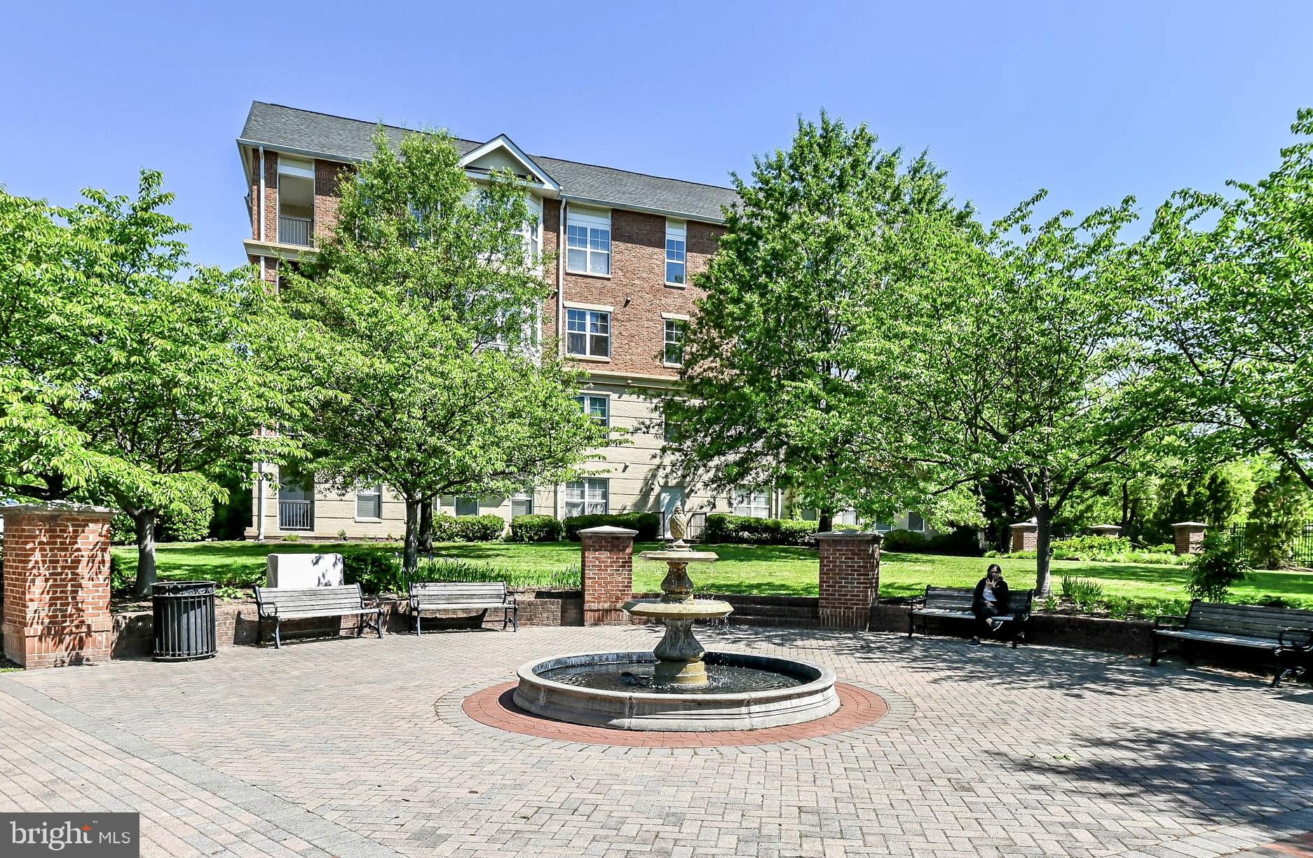Enjoy the open floor plan of this charming, ELEVATOR ACCESSIBLE, penthouse unit, located a couple blocks from Historic Downtown Herndon and the W&OD bike trail.  Gleaming hardwood covers the flooring in the main rooms of the unit.  The primary suite includes a spacious ensuite bathroom with dual vanities and a separate tub and shower.  A large walk-in closet with convenient built-in shelving is one of the two closets completing  the primary suite.  Both bedrooms include ceiling fans providing additional temperature control and overhead lighting.  The gourmet kitchen includes gas cooking, a built-in microwave, loads of cabinets and an expansive breakfast bar for casual dining.  The kitchen opens to both the spacious living room and the formal dining room making the layout perfect for entertaining.    For a taste of the outdoors, step out onto the private balcony from the  living room for a view of trees below.  Recently updated washer and dryer are conveniently included in unit.  Go straight by elevator from your GARAGE PARKING space (#30),  located in the gated underground parking garage to your fourth floor apartment.   Additional parking is available in the side parking lot and on the street.  Recent Updates: Fifty gallon hot water heater 3 years; Windows 4 years; Washer/Dryer 5 years.  Enjoy the treasures of downtown Herndon with all its restaurants, shops, the farmers market, the library, and much more!!