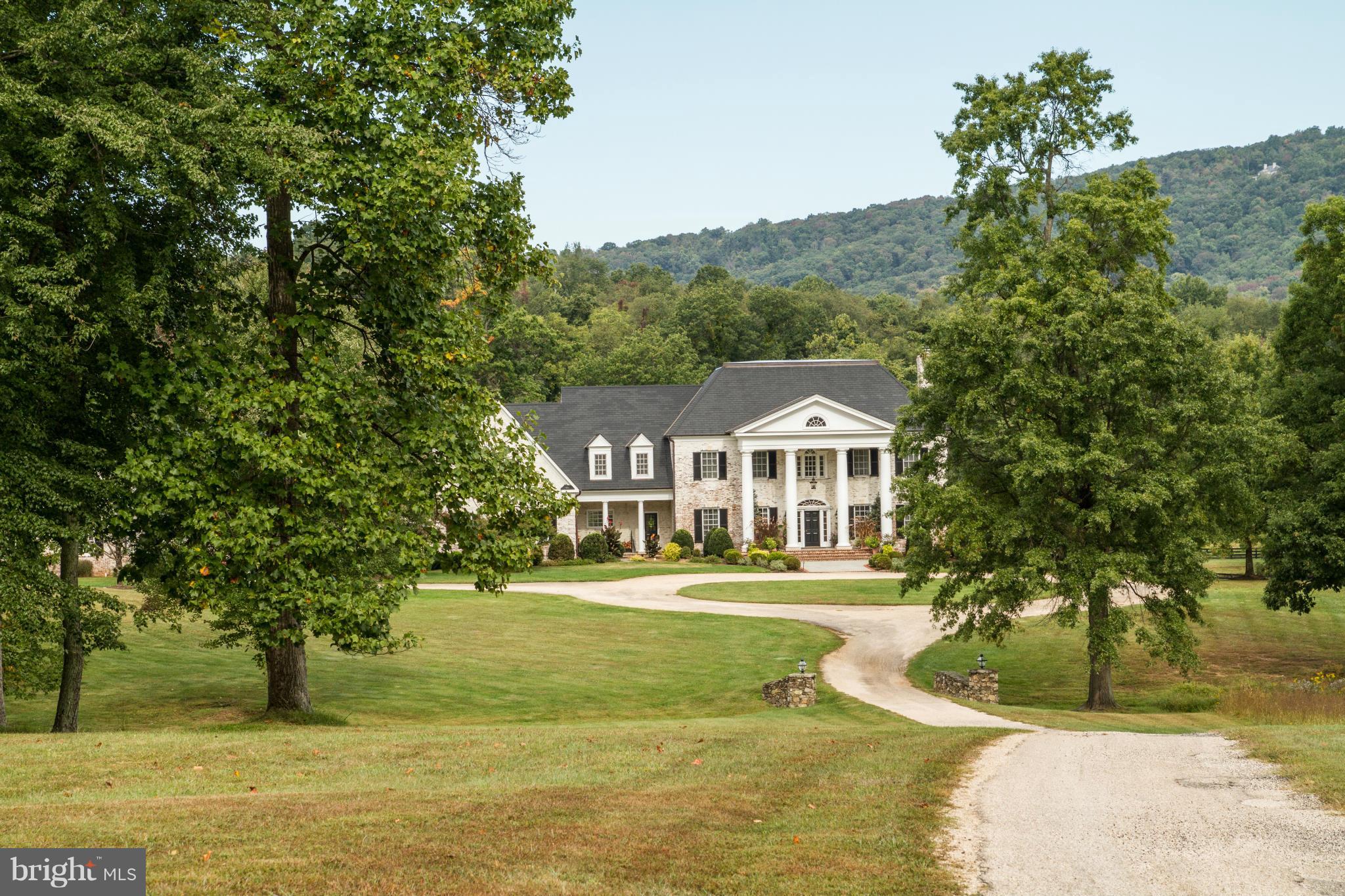 REDUCED - Extraordinary brick colonial on 50+ gorgeous acres in prestigious Greystone. Over 9000 sq.ft.of spectacular living space featuring 3 beautifully finished levels. Heated pool, tennis court and brilliant gardens overlook a picturesque pond with fabulous mtn views,in a private & secluded location.