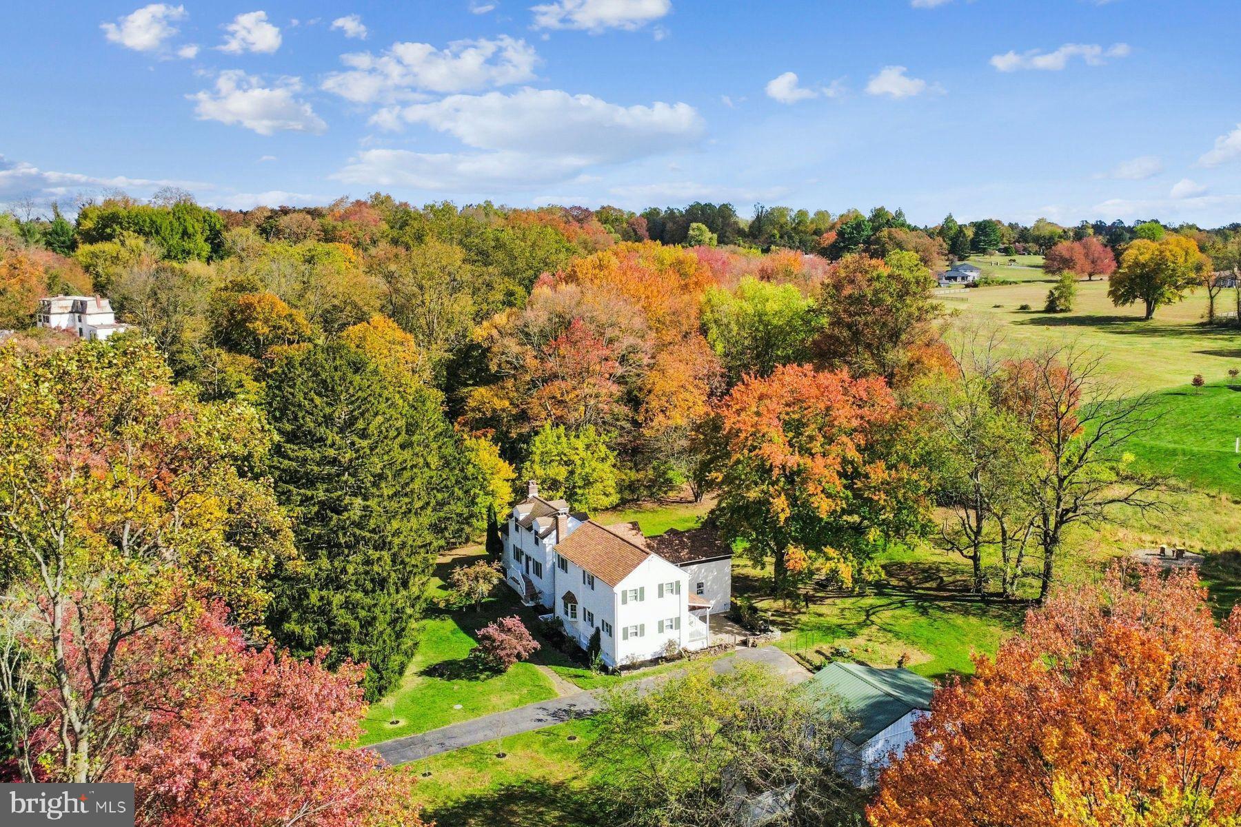 Set on four private, peaceful acres in sought-after Glen Mills, 1554 Meadow Lane is a beautifully restored 1766 stone farmhouse that blends historic character with modern comfort.

Originally part of William Penn’s “First Purchasers” land grant (1681) and once part of a historically significant dairy farm operation in the tri-state area, the property carries deep roots in early American history while offering the space, privacy, and flexibility today’s buyers seek.

Thoughtfully expanded through two additions (1970s and 2001), the home now offers 3,378 sq ft with a functional and flexible layout. The 5-bedroom, 2.5-bath residence showcases original plank flooring, exposed stonework, and three fireplaces, seamlessly paired with thoughtful updates including a renovated kitchen, new smart appliances, 3-zone mini-split system, PEX plumbing, updated electrical panel, and a smart hybrid heat pump water heater.

The private two-story in-law addition with its own entrances, full kitchen, fireplace, spacious bedroom with en-suite powder room, and a generous living area provides ideal flexibility for multi-generational living, guests, au pair quarters, or a dedicated home office.

The land is where this property truly stands apart—open meadows, mature trees, producing apple and pear trees, edible berries, and wooded walking trails create a setting suited for homesteading, recreation, or a peaceful retreat. A stream and multiple natural springs enhance the wooded portion of the property and support a thriving ecosystem. The property is home to 85+ documented bird species along with deer, fox, and other wildlife. A rare spring-fed water system has reliably served the home for over 250 years, offering a unique sense of sustainability and connection to the land.

An oversized two-car garage with electric provides ample space for storage, equipment, or workshop use.

With potential for future subdivision (buyer to verify), the property offers both immediate lifestyle appeal and long-term flexibility.

Located in the award-winning Rose Tree Media School District, just 5 minutes from Ridley Creek State Park, minutes to Media, West Chester, and Newtown Square, and approximately 30 minutes to Philadelphia and Wilmington.

A distinctive property where history, land, and modern living come together.

Seller is a licensed Realtor® in Arizona.