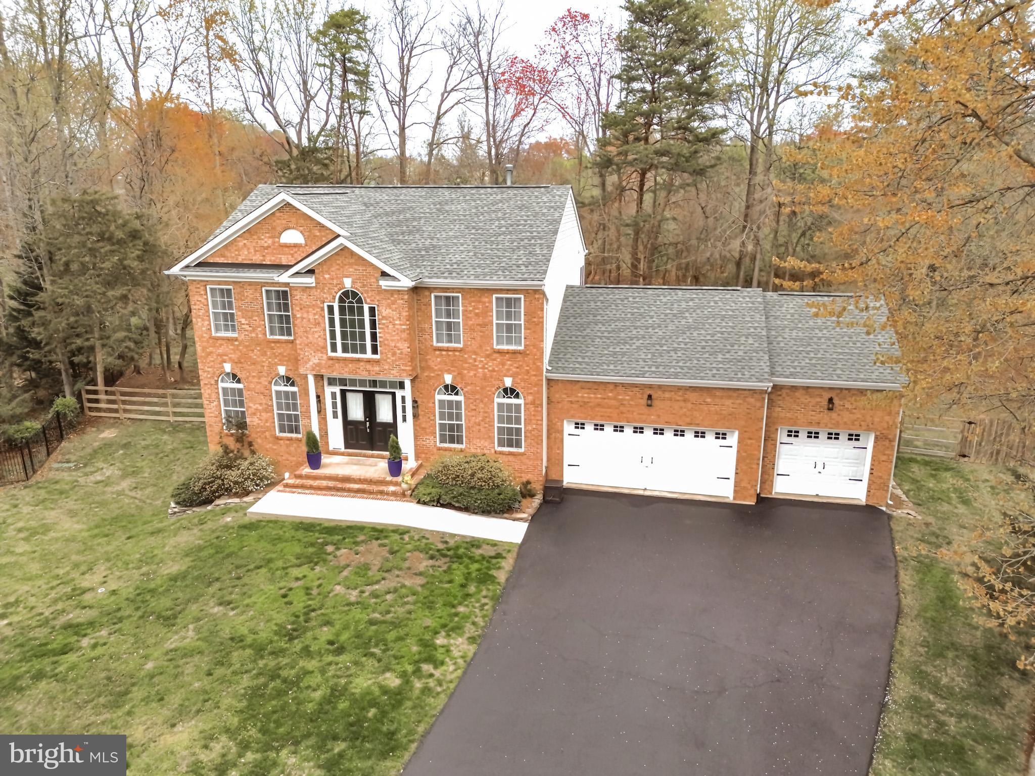 Charming 4-Bedroom Home on 0.57 Acres with Expansive Features

Welcome to this beautiful 4-bedroom, 4-bathroom home with 3 car garage situated on a generous 0.57-acre lot. From the striking brick front to the inviting double front doors, this residence exudes curb appeal and comfort.

As you enter, you’re greeted by a grand two-story foyer with gleaming hardwood floors and a stunning wood staircase. The spacious dining room/office features hardwood flooring, crown molding, and chair rail detailing, providing the perfect space for family gatherings, special occasions, or a productive home office. The living room, with access to the rear deck, boasts vaulted ceilings, hardwood flooring, and a cozy gas fireplace, seamlessly opening into the kitchen. The gourmet kitchen is equipped with granite countertops, a 5-burner gas stove, a center island, and ample pantry storage. The sunny sunroom, with its hardwood flooring and wood ceiling, is absolutely stunning and leads directly to the rear deck.

Conveniently located on the main level, a bedroom with carpeted flooring joins a full bath off the hallway, ideal for guests or multi-generational living. The mudroom off the garage is a standout feature, offering ample storage space to keep things organized.

Upstairs, the spacious primary bedroom is complete with hardwood flooring, a ceiling fan, and a generous walk-in closet with two additional closets for extra storage. The en-suite bathroom features custom tile flooring, a separate shower, a soaking tub, and a double-sink vanity, creating a spa-like retreat. Two additional well-sized bedrooms with hardwood flooring share a beautifully tiled hall bathroom, which includes a separate shower and a single-sink vanity. The upstairs landing is open and overlooks the living room, enhancing the sense of space and light throughout.

The finished lower level boasts a large family room with luxury vinyl plank flooring and a ceiling fan, offering the perfect space for recreation or entertaining. A lower-level bathroom with tile flooring and a tub/shower combination adds to the convenience of this home. An additional room provides flexible space for various uses, and a large storage room, along with the laundry room, completes this walkout basement.

The fenced rear yard is perfect for outdoor activities, and the deck is an excellent spot for grilling and enjoying time with family and friends.

With its fantastic layout and thoughtful details, this home offers both comfort and style in a fantastic location. Don't miss out on this stunning property!