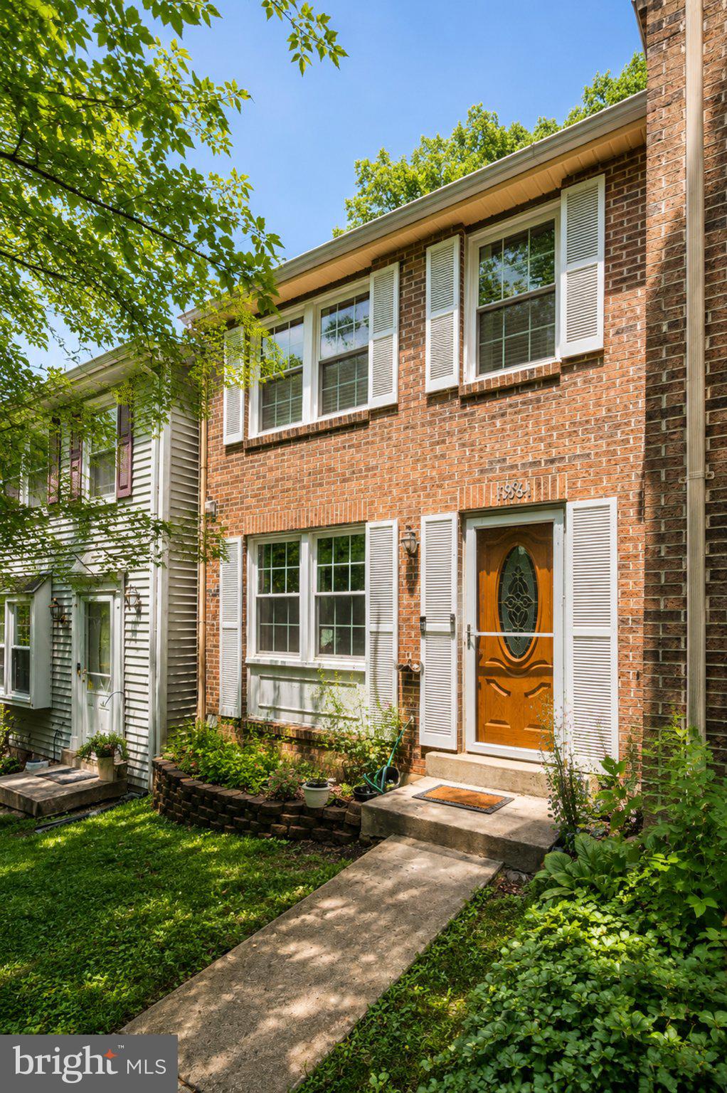 Beautifully maintained 3-bedroom, 3-level brick-front townhouse nestled in a quiet, established community. The inviting main level features a hardwood foyer leading to a spacious living and dining area, perfect for everyday living and entertaining. The updated kitchen boasts brand-new granite countertops, abundant cabinet space, and a functional layout for any home chef. Major mechanical updates include a new furnace and water heater, both replaced in 2025, providing added comfort and peace of mind. The walkout lower level opens to a private, fully fenced backyard with a patio overlooking a serene wooded park, offering the perfect setting for relaxation or outdoor gatherings. Includes two reserved parking spaces (#412 & #413). Conveniently located near shopping, dining, major commuter routes, shopping, restaurants, and public transportation.Seller need HOC Contingecy