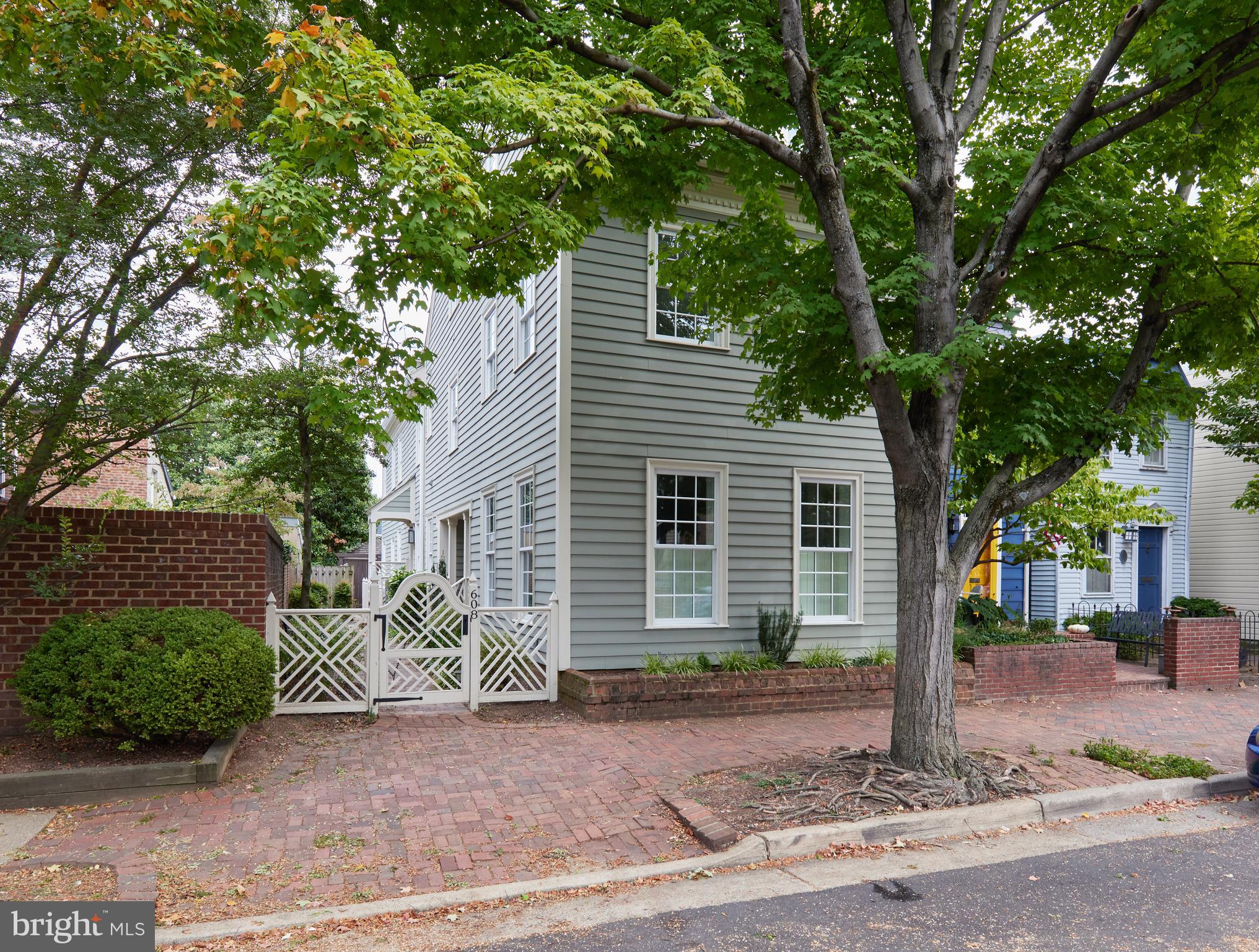 Renovated and updated semidetached federal style townhouse in Old Town. This lovely, light-filled three-story home has a quiet side entrance creating a private oasis at your front door. On the main level, you're greeted by a lofted foyer opening to a formal living room with fireplace and built-in bookshelves, large formal dining room, a gourmet chef's kitchen with wet bar adjacent to a bright Family Room with fireplace and half bath. The grand stairway leads upward to a 2nd floor en suite primary bedroom, with fireplace and french doors overlooking the garden plus a 2nd bedroom and bath. 3rd and 4th bedrooms and 2 baths are on the third floor. The spacious property is surrounded by a lovely brick walkway and planted garden connecting to a private terrace and parking.
